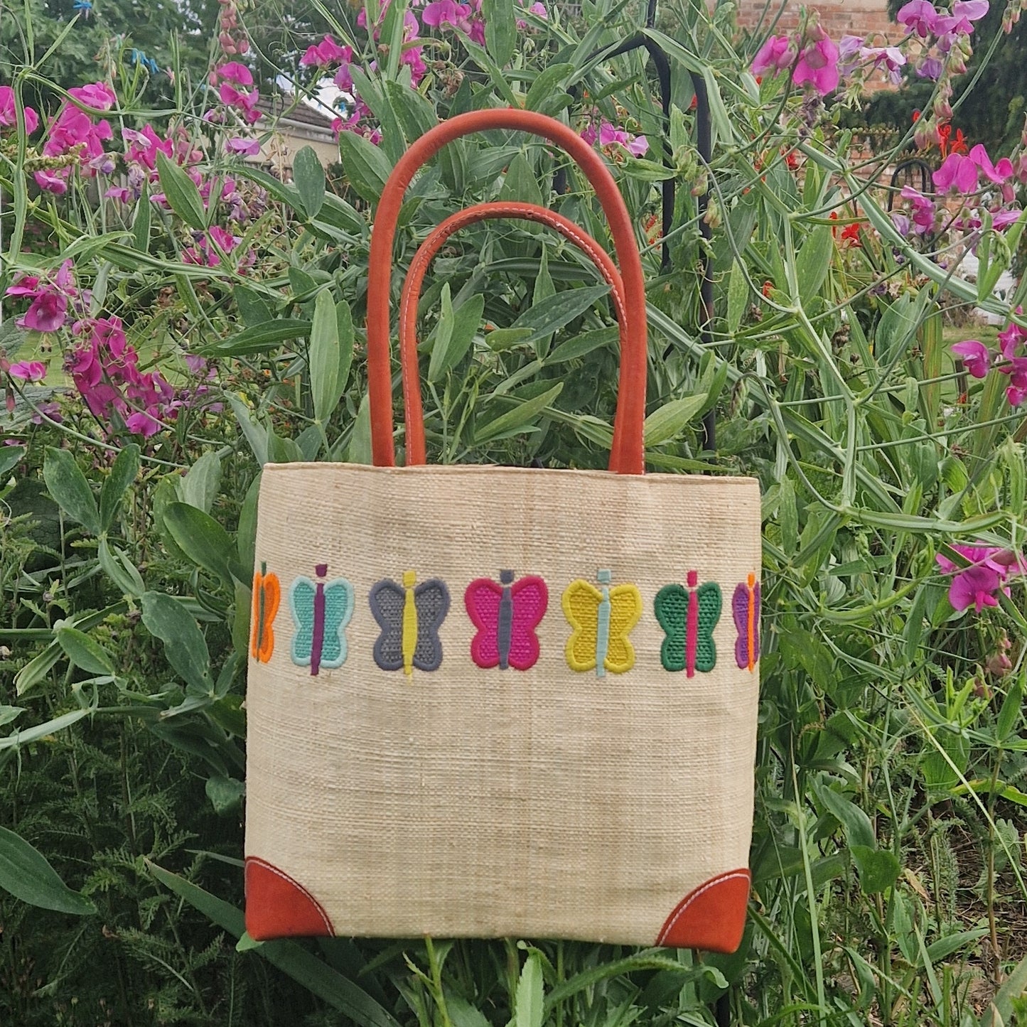 Natural Raffia Basket decorated with a ring of coloured butterflies