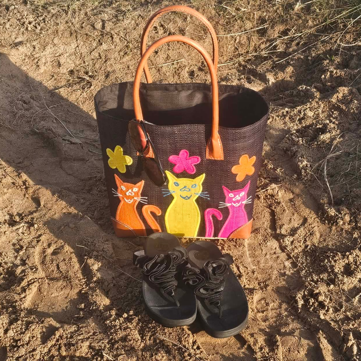 Black Raffia Baskets decorated with colourful cheeky cats in bright pink, yellow and orange.
