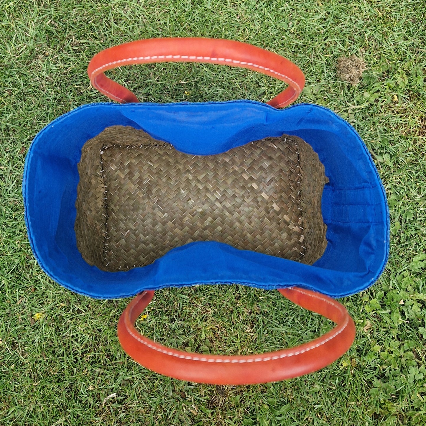 Top down view inside a blue raffia basket.
