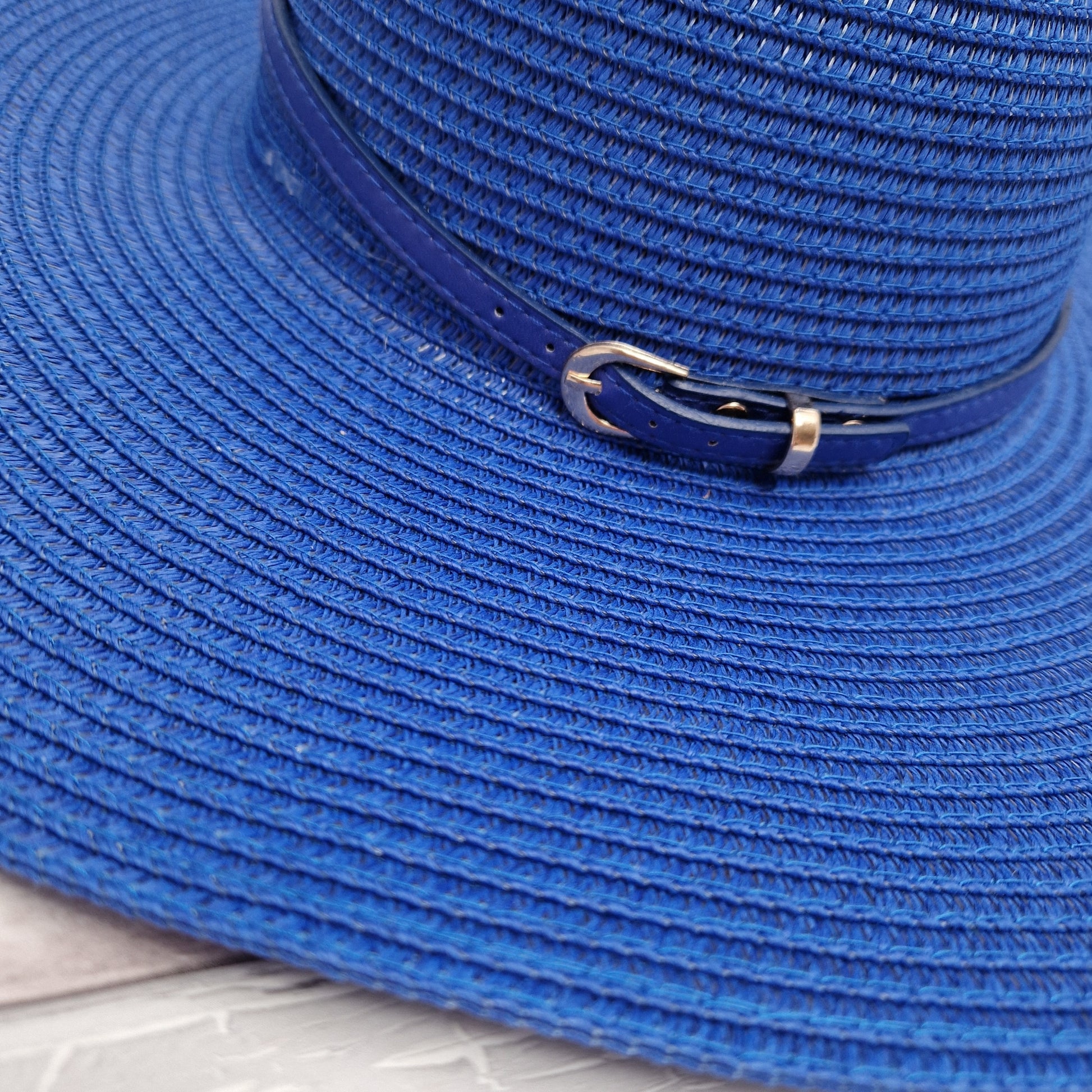Royal Blue wide brimmed fat with matching coloured belted band.