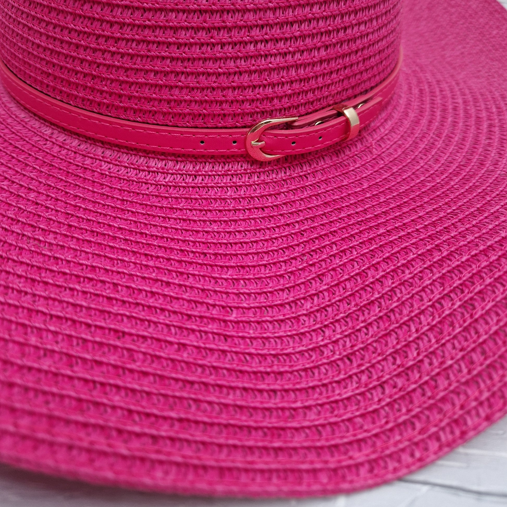 Hot Pink wide brimmed fat with matching coloured belted band.