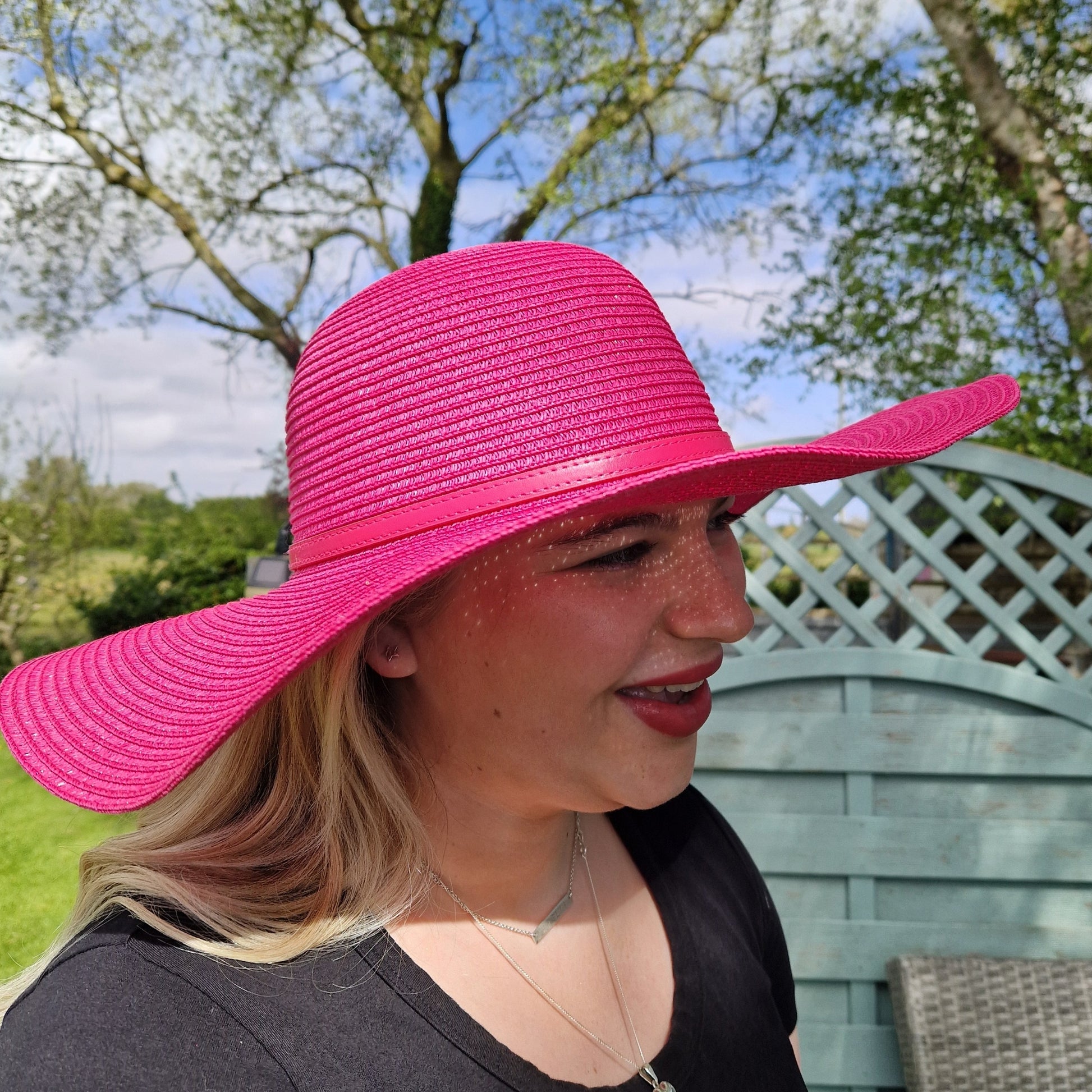 Hot Pink wide brimmed fat with matching coloured belted band.