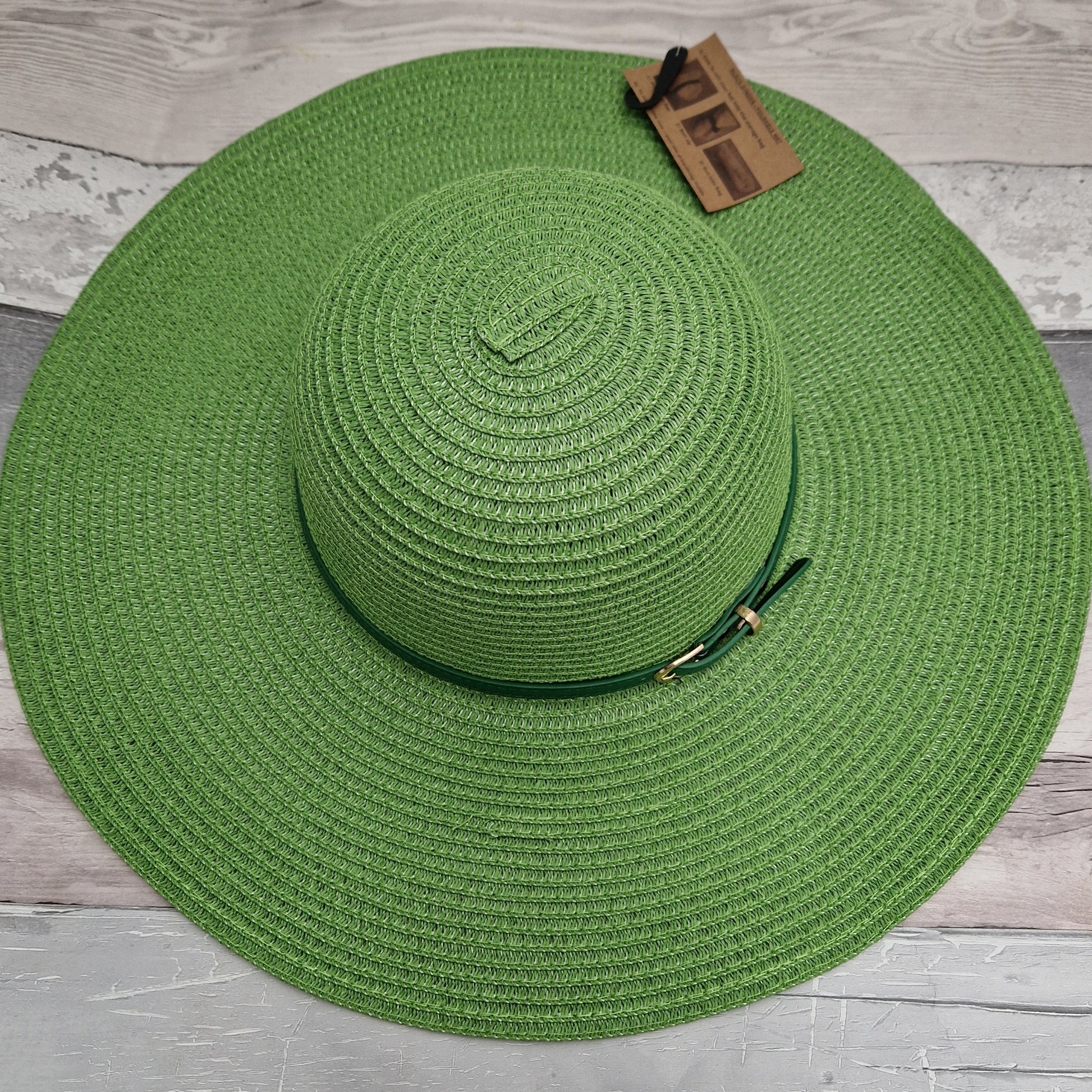 Wide brimmed emerald green hat with matching belted band.