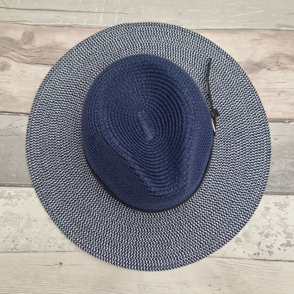 Top down view of a Blue Panama hat with a black belted trim.