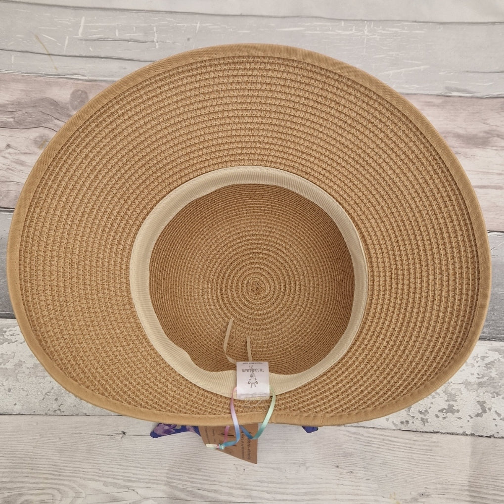 Internal view of a beige coloured backless bonnet. An adjustable band can be seen around the inside rim of the crown.