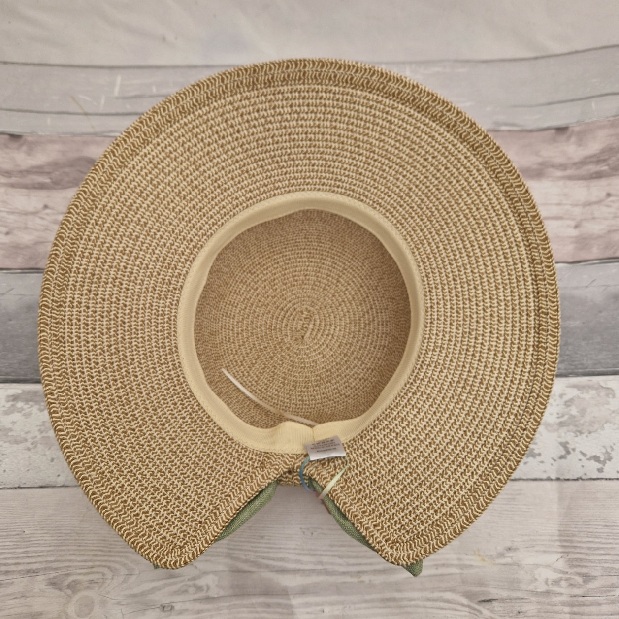 Inside view of a backless bonnet. Adjustable band visible inside rim of hat.