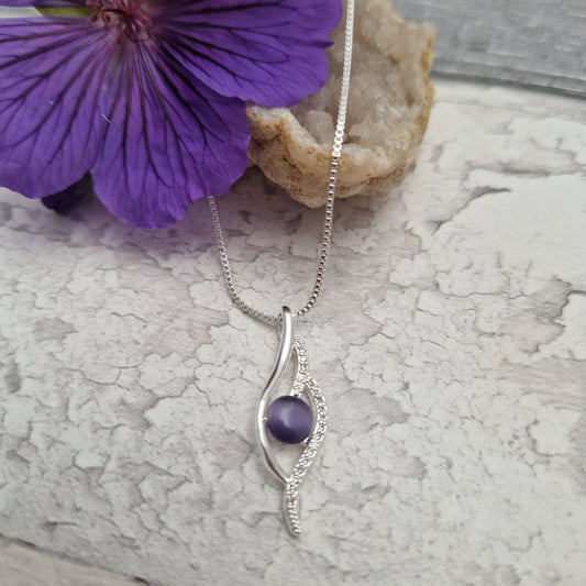 Purple Moonstone Pendant on a silver plated necklace.