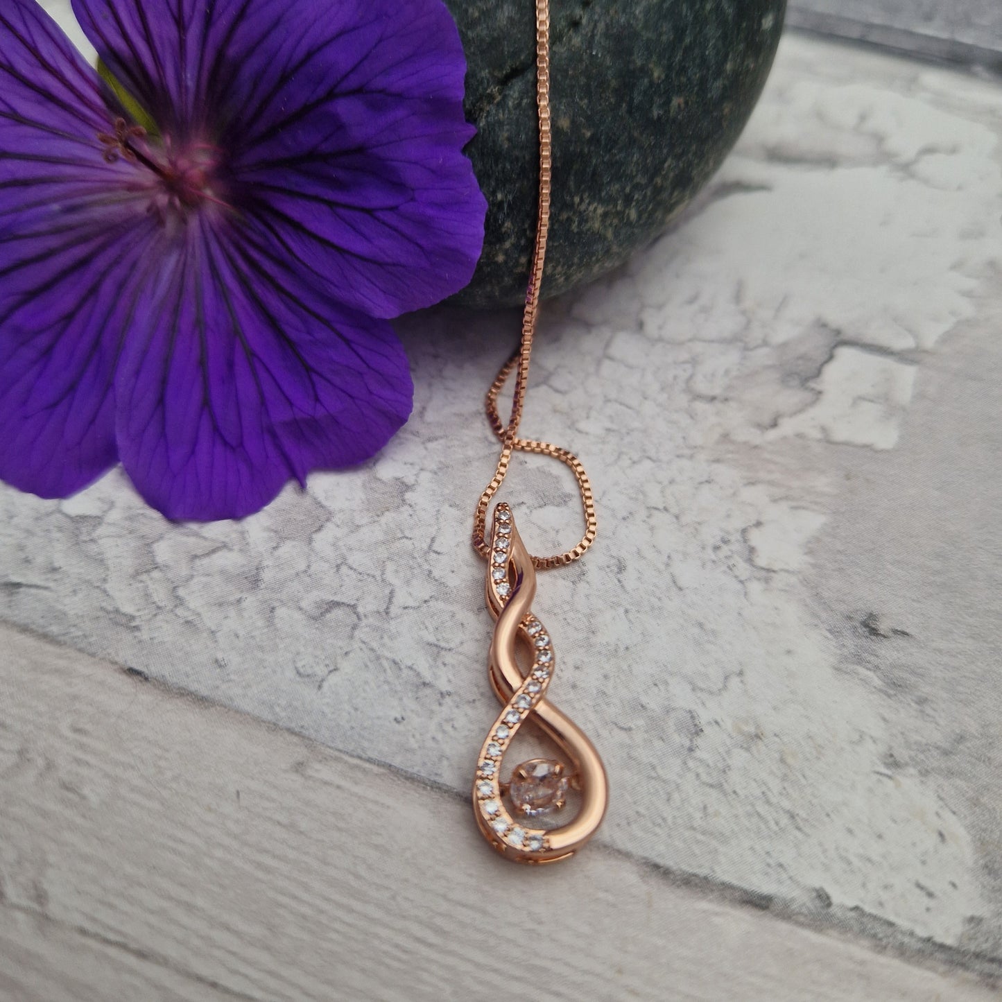 Rose gold plated pendant in a twist pattern, decorated with diamante crystals.