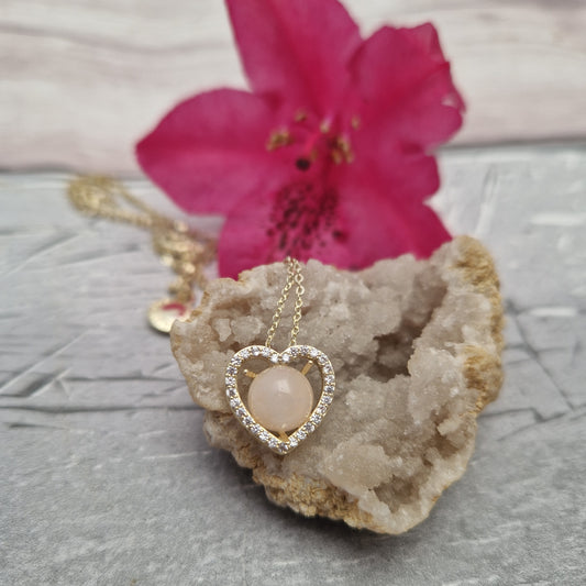 Rose quartz set in a love heart pendant on a gold coloured necklace