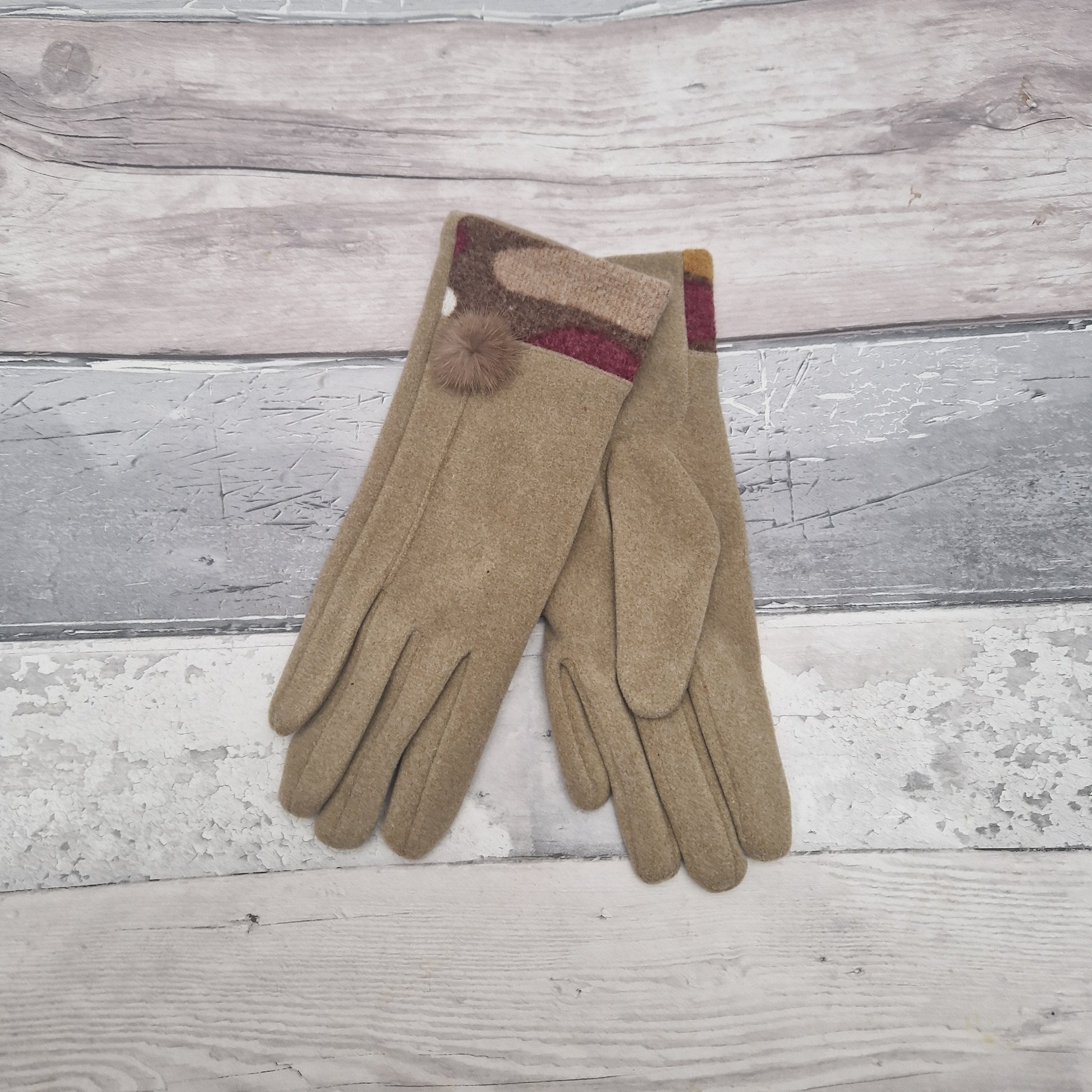 Camel coloured gift boxed gloves with a jazzy coloured cuff and fluffy pop pom.