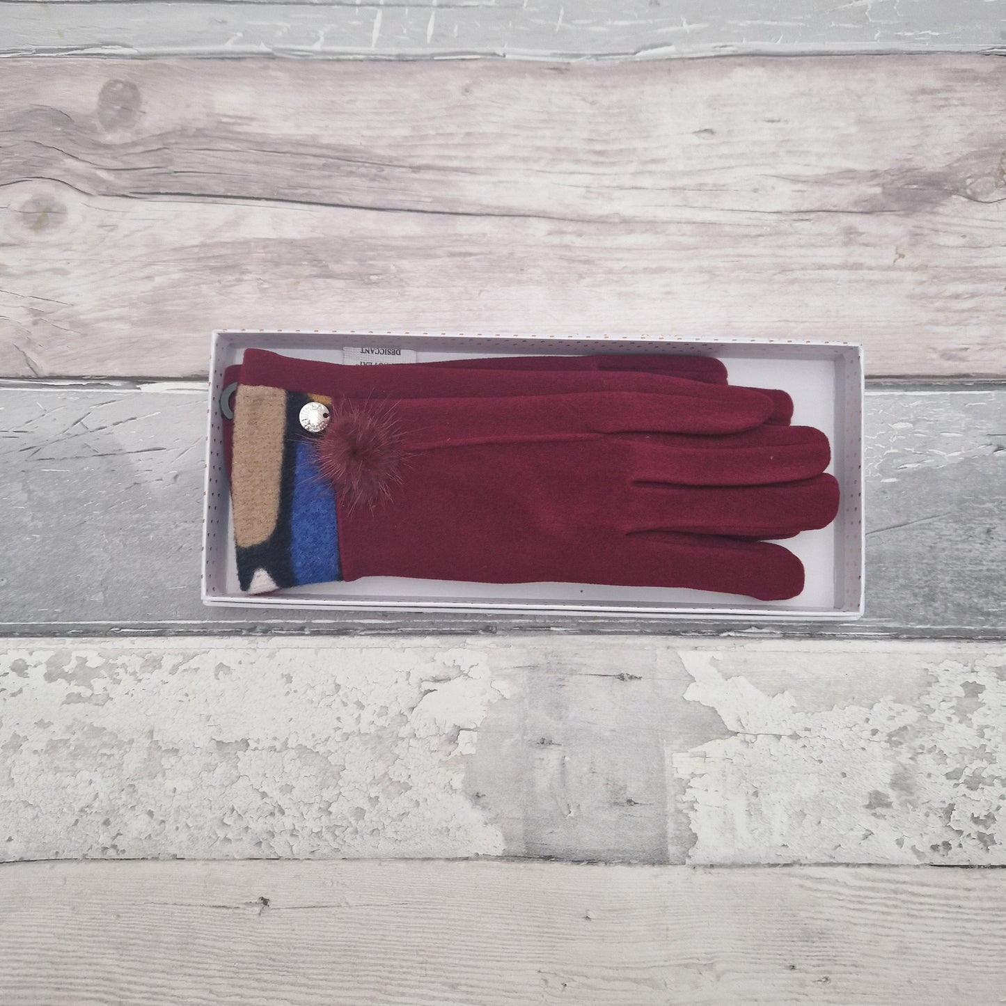 Red gift boxed gloves with a jazzy coloured cuff and fluffy pom pom