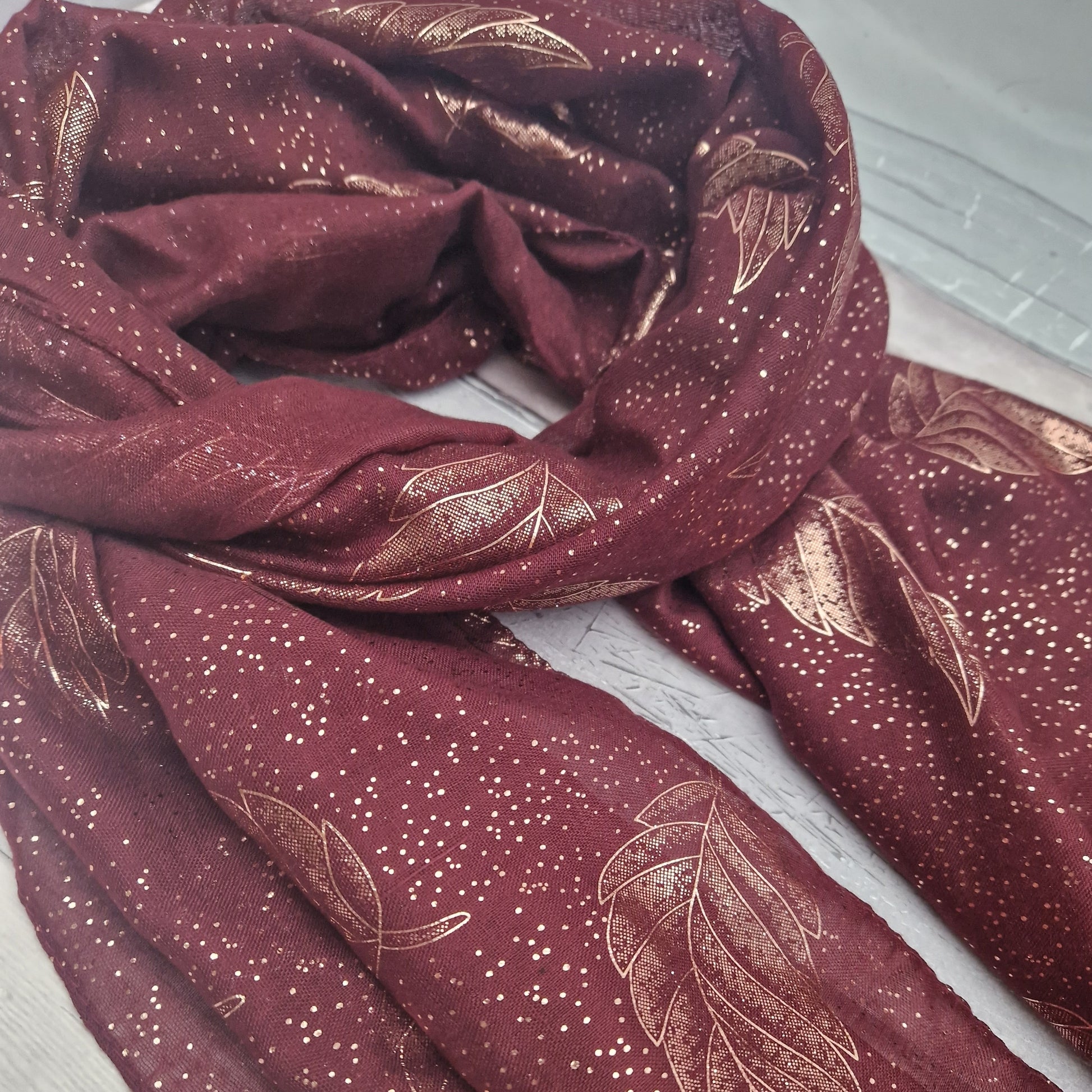 Gift Boxed Burgundy coloured scarf with leaf pattern in metallic rose gold.