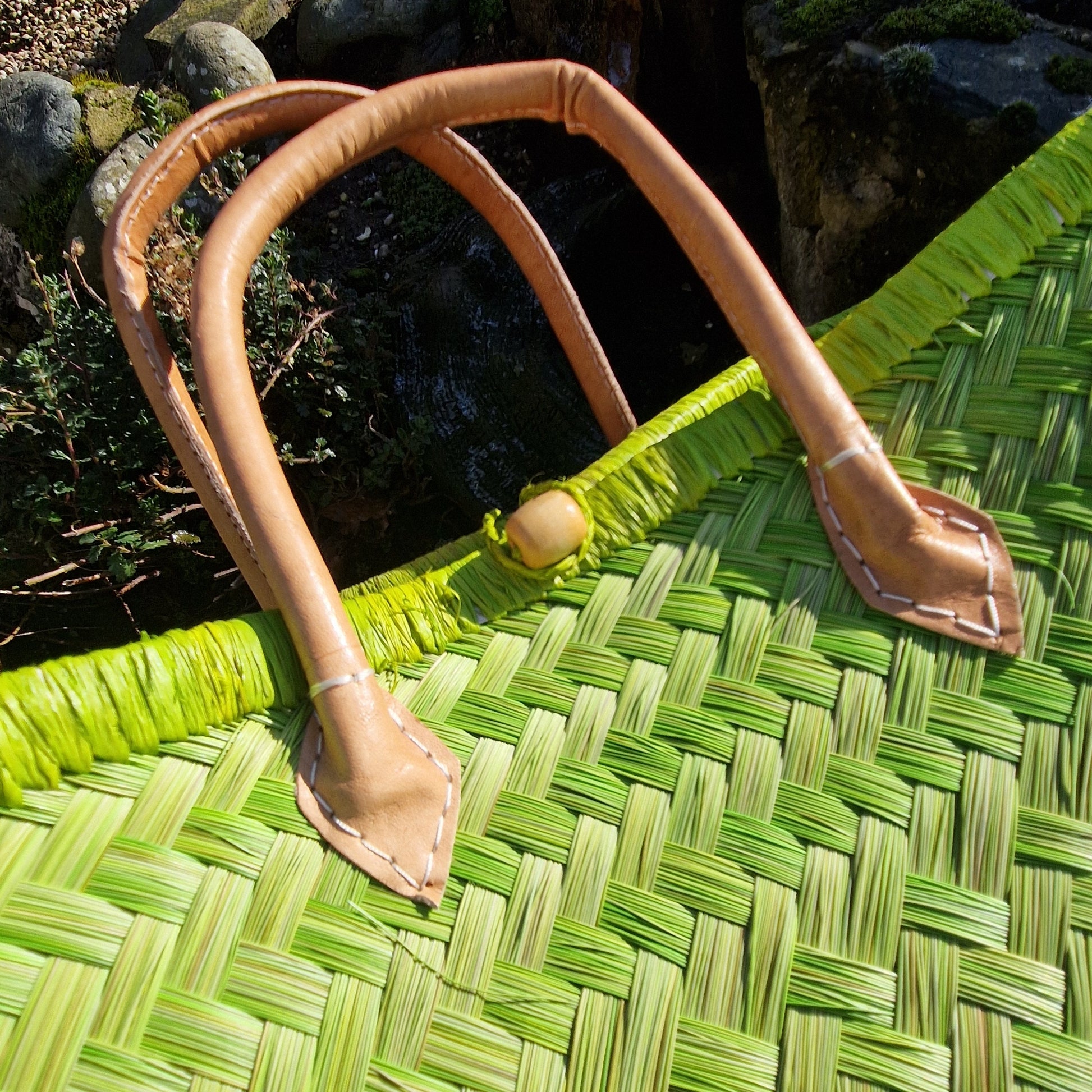 Lime Green woven basket with leather handles.