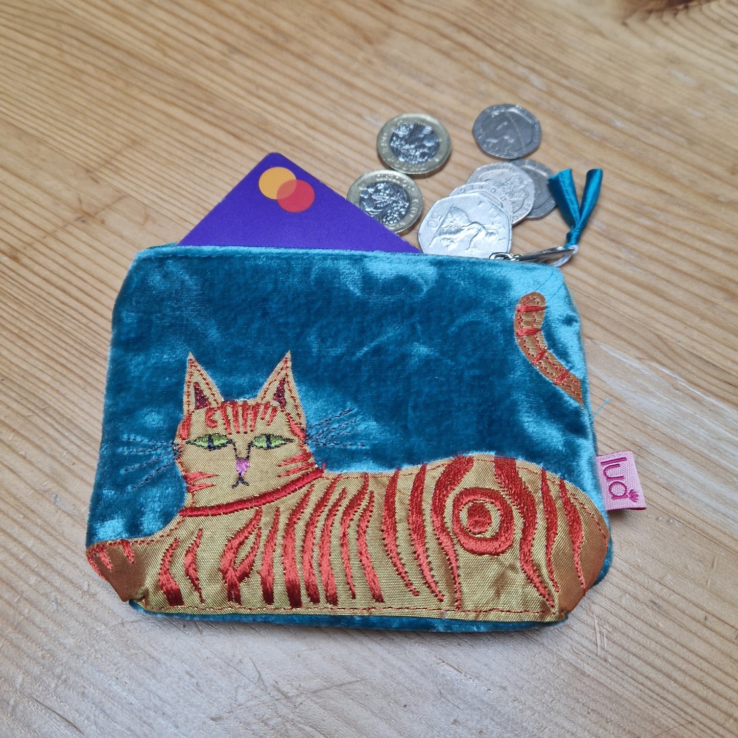 Coin purse with cat design on a wooden surface