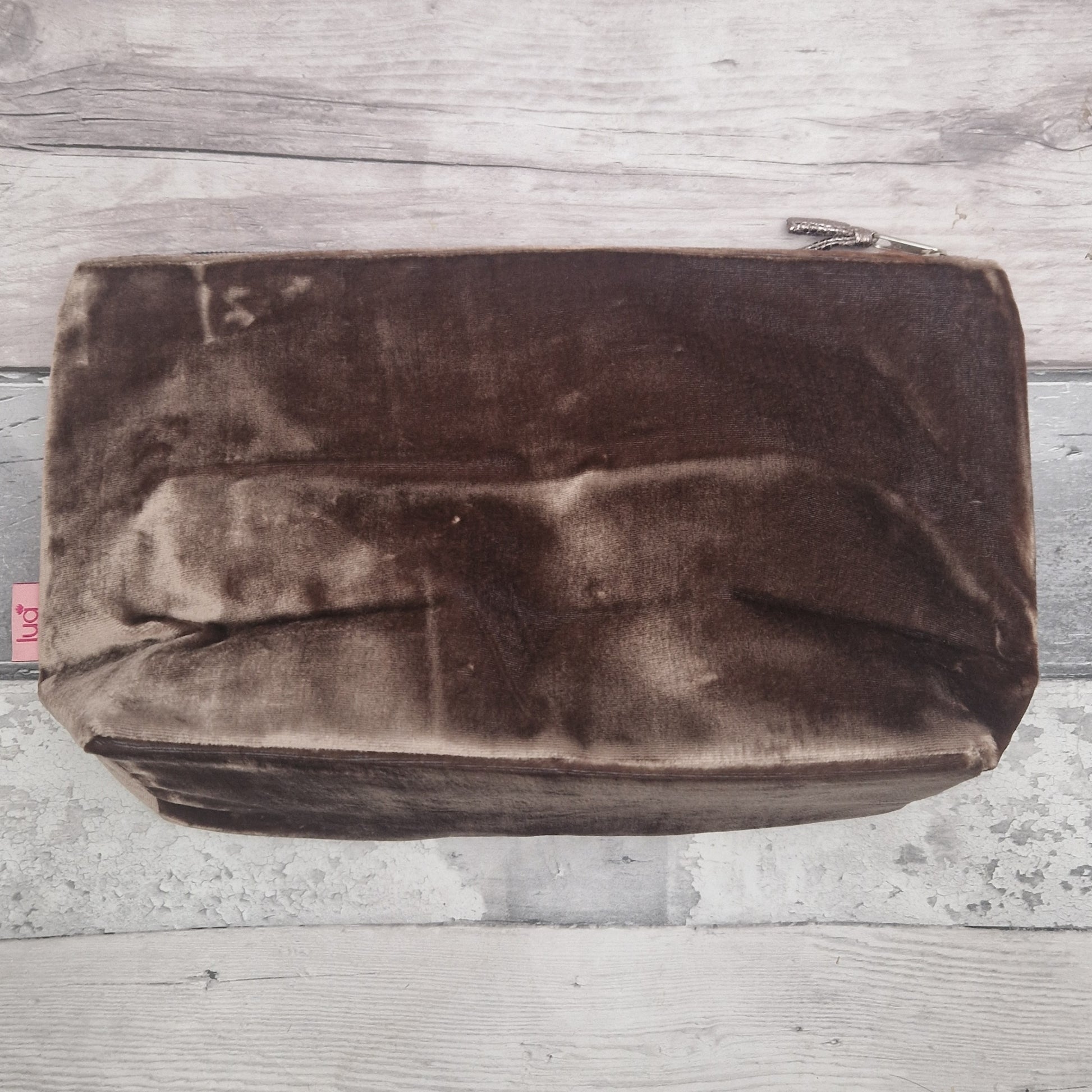 Brown velvet pouch on a wooden surface