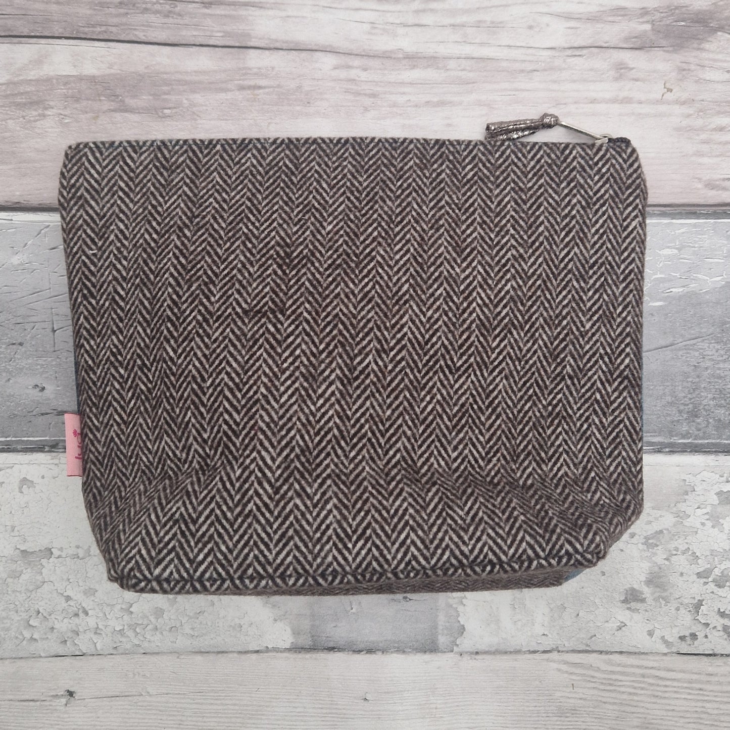 Tweed patterned pouch on a wooden surface