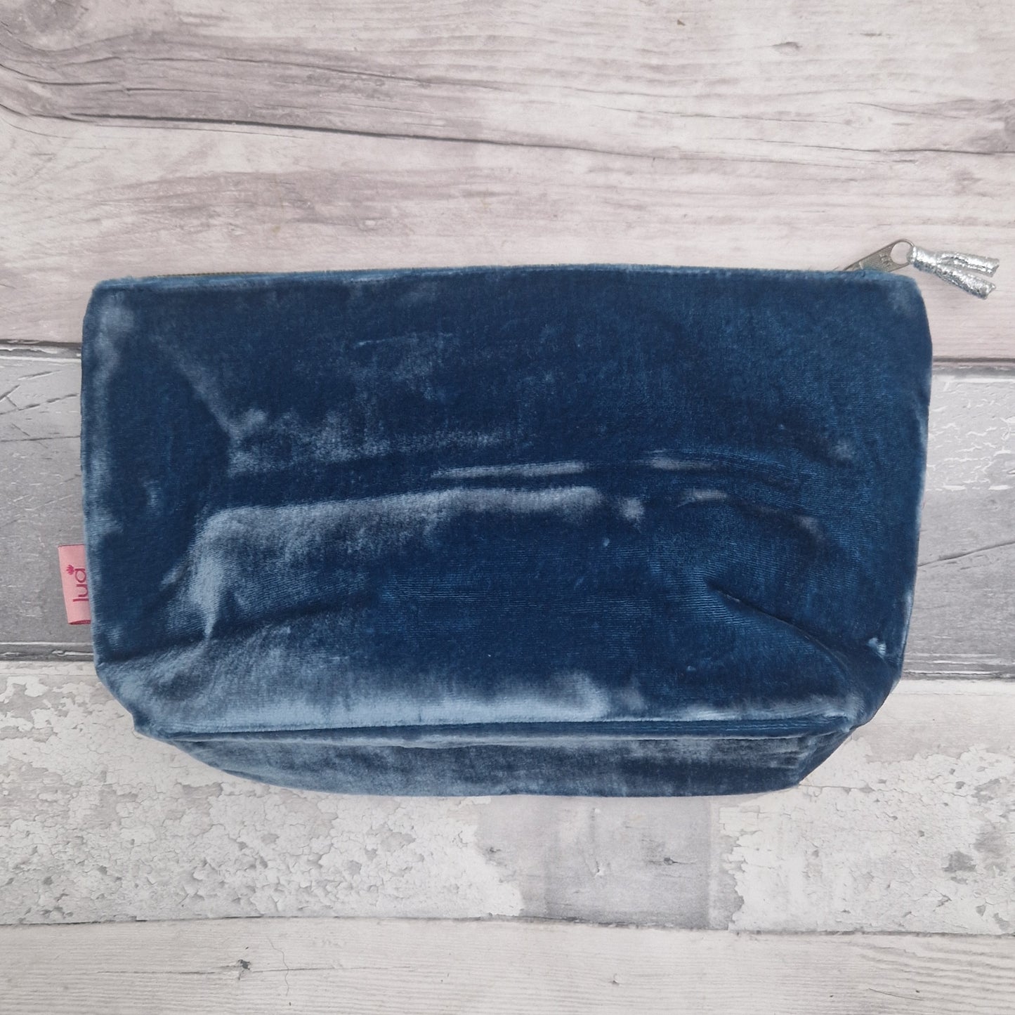 Blue velvet pouch on a wooden surface