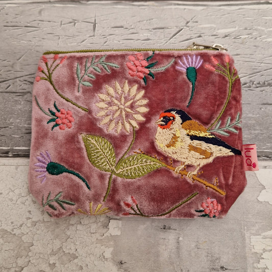 Pink velvet coin purse decorated with flowers of pink and purple and embroidered depiction of a Goldfinch.