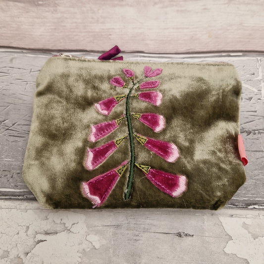 Green velvet coin purse decorated with a pink foxglove stem.