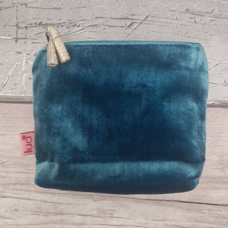 Reverse side of at turquoise blue velvet coin purse.