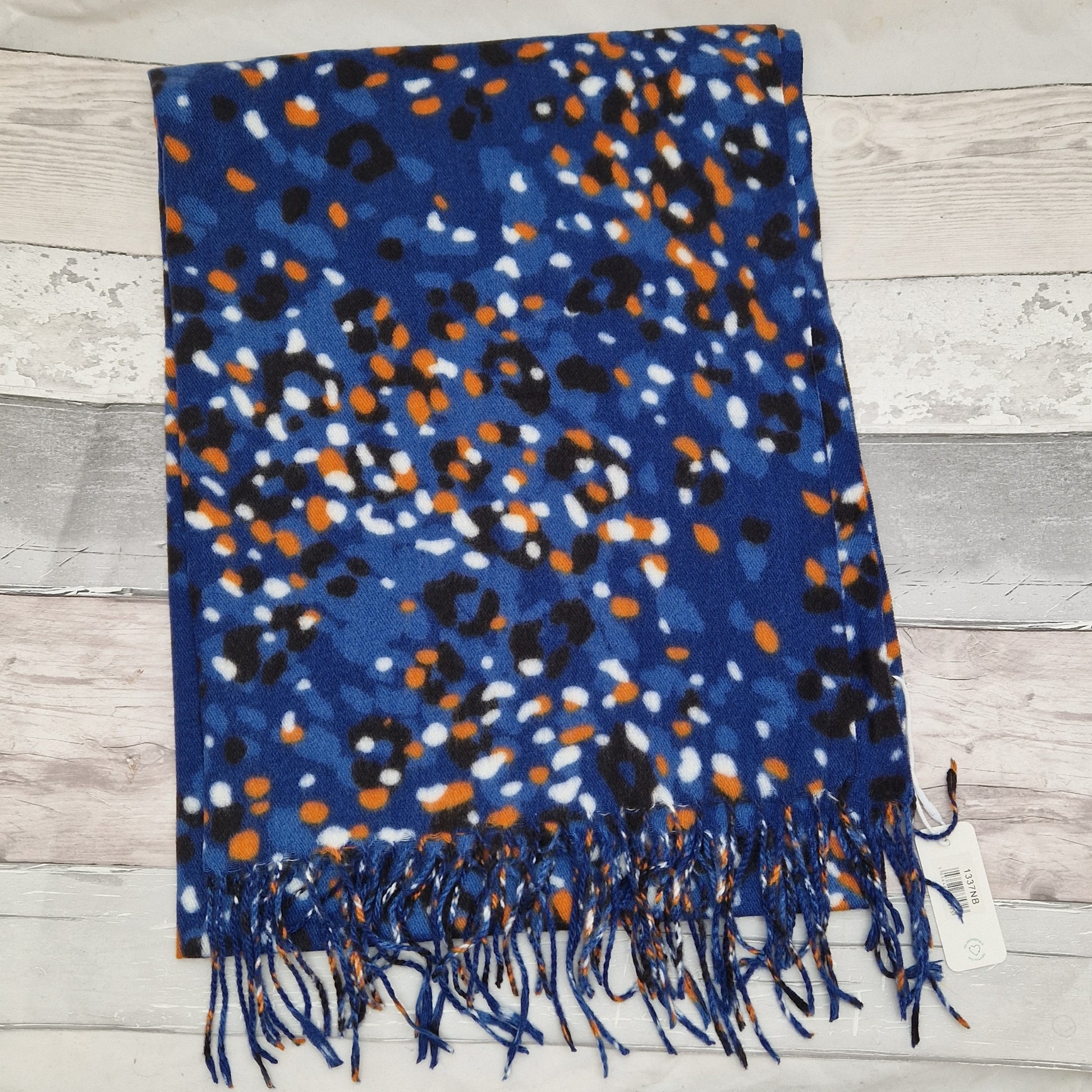 Electric blue scarf with a black leopard print overlaid with spots of orange and white.