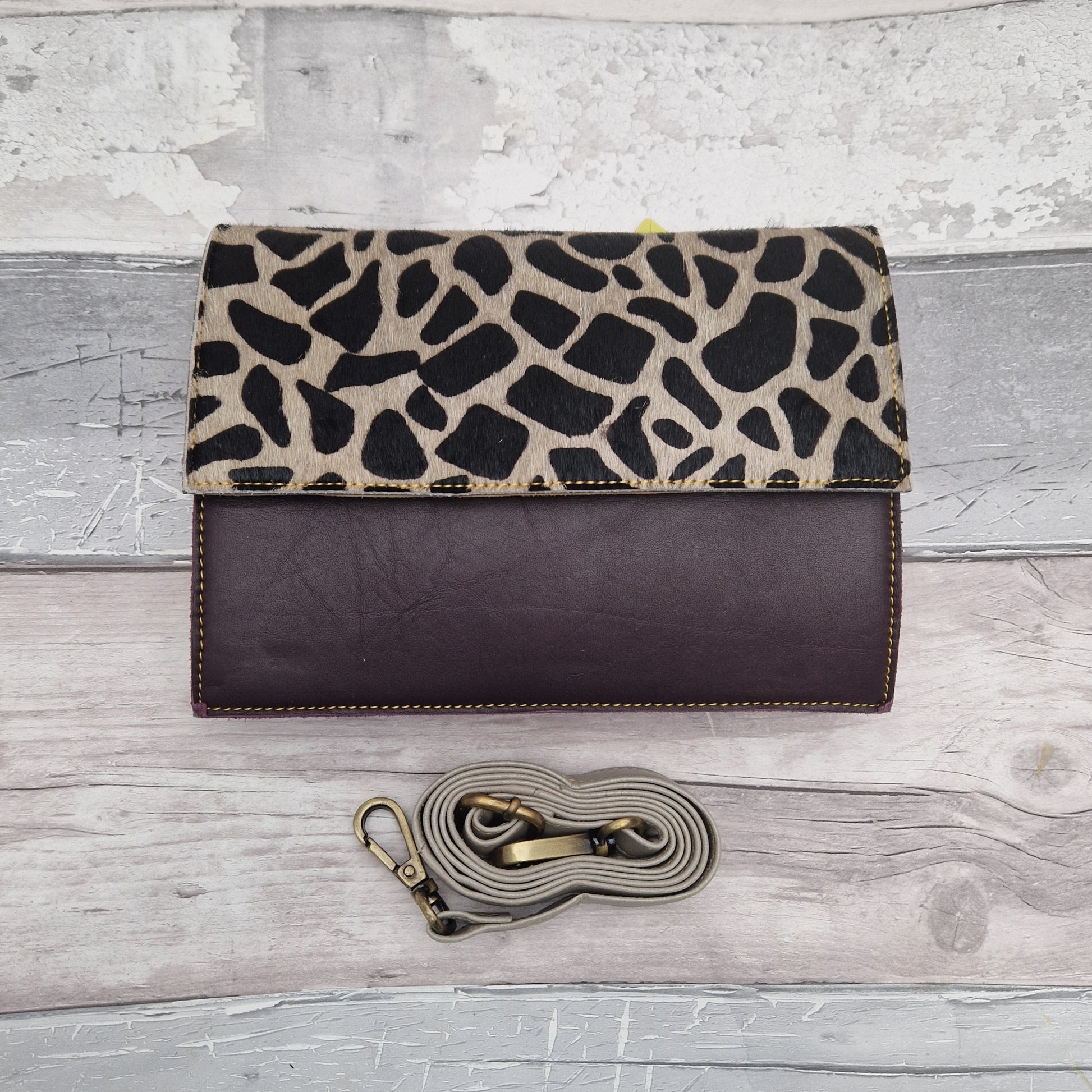 Burgundy leather bag with a textured panel of Giraffe Print.