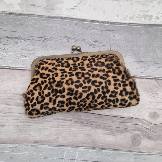 Leopard print clutch bag in a textured finish.