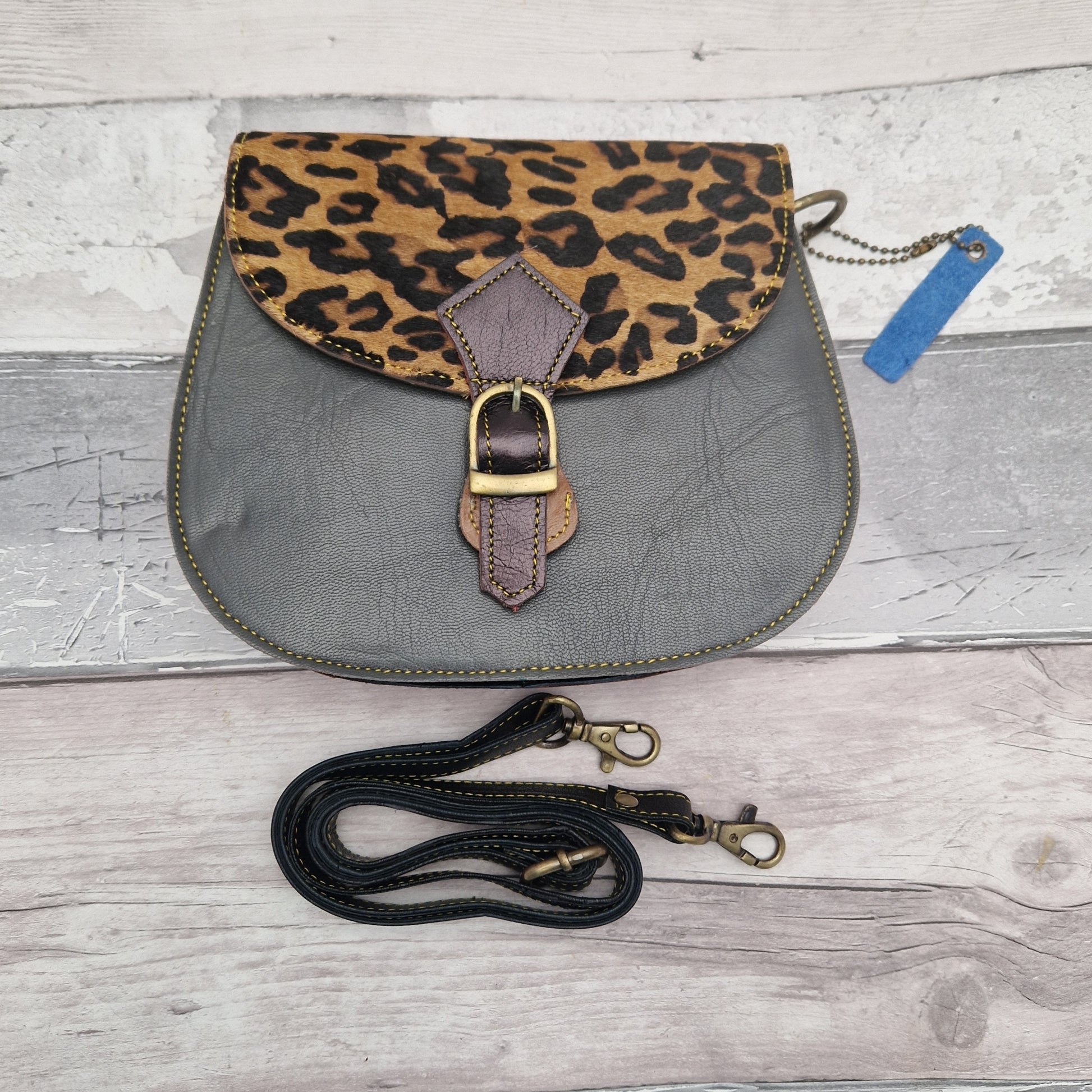 Grey leather bag with a textured panel of Jaguar print.