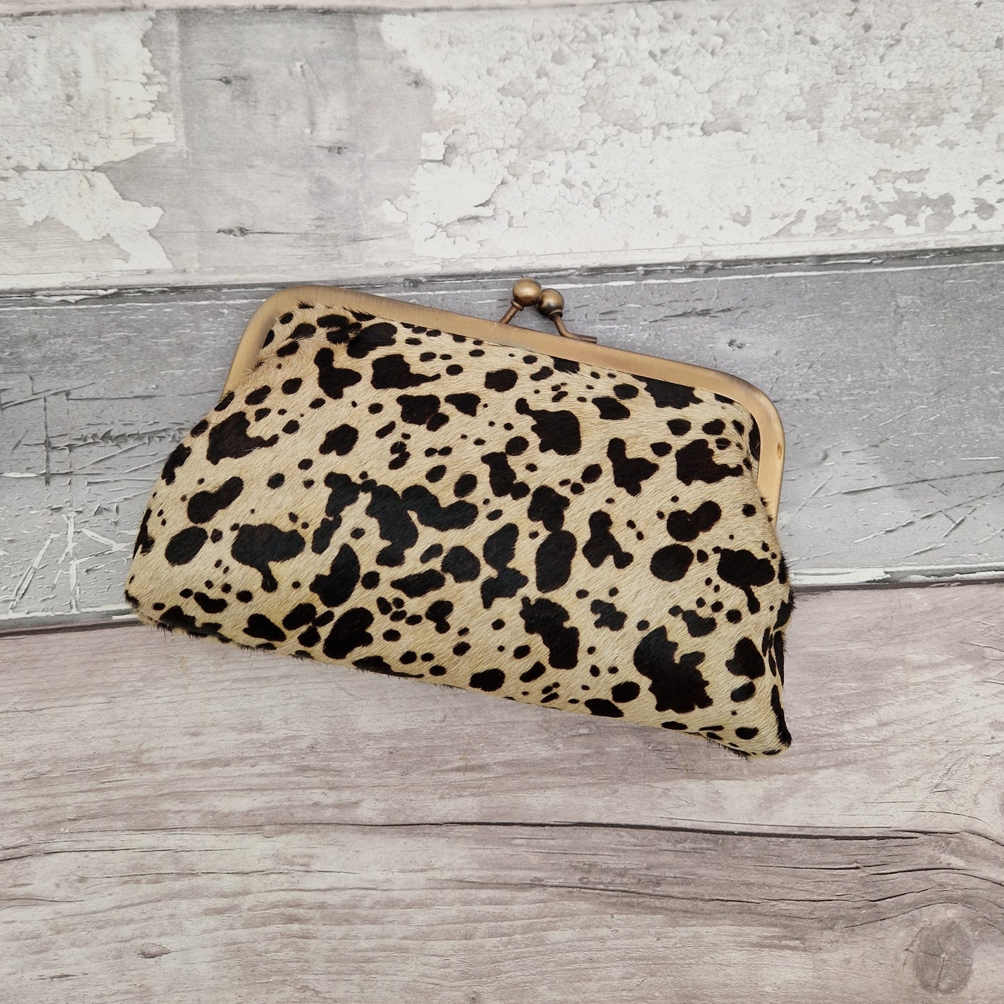 Clutch bag in textured cow hide finish.