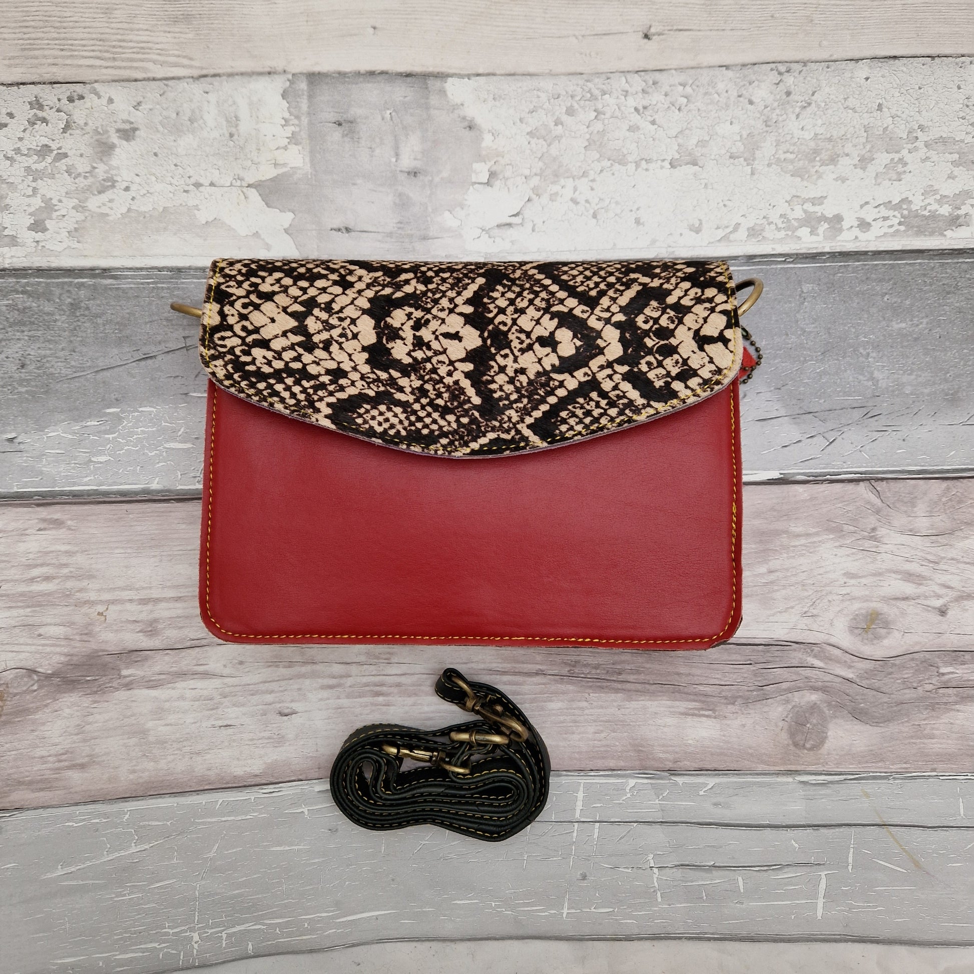Red Leather clutch bag with a snakeskin print textured envelope style panel.