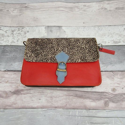 Stunning red leather bag with a textured panel in black with white micro spots.