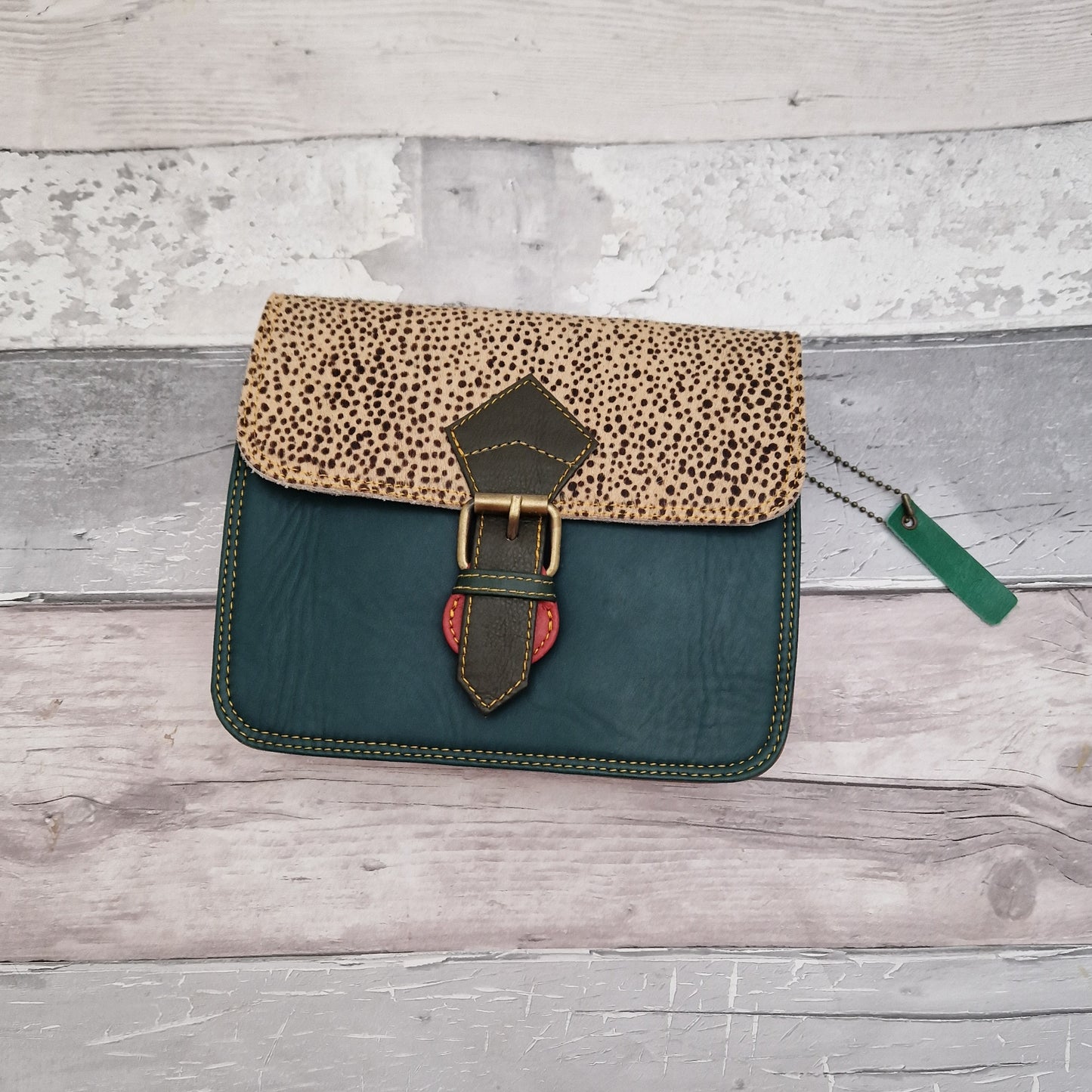 Green Leather crossbody bag with a textured panel in a micro spot print.