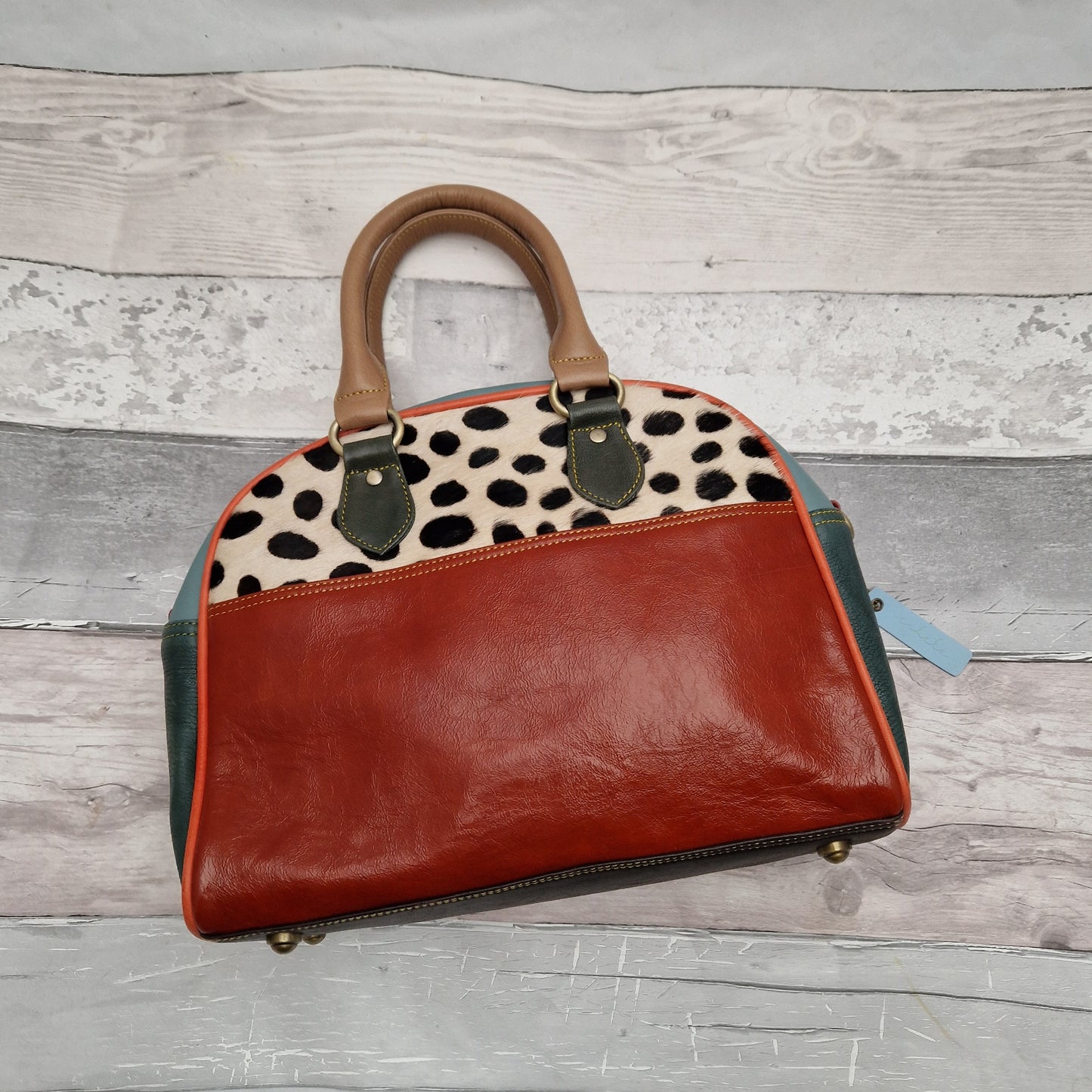 Red leather bowling style bag with textured spotty panel. All leather off cuts.