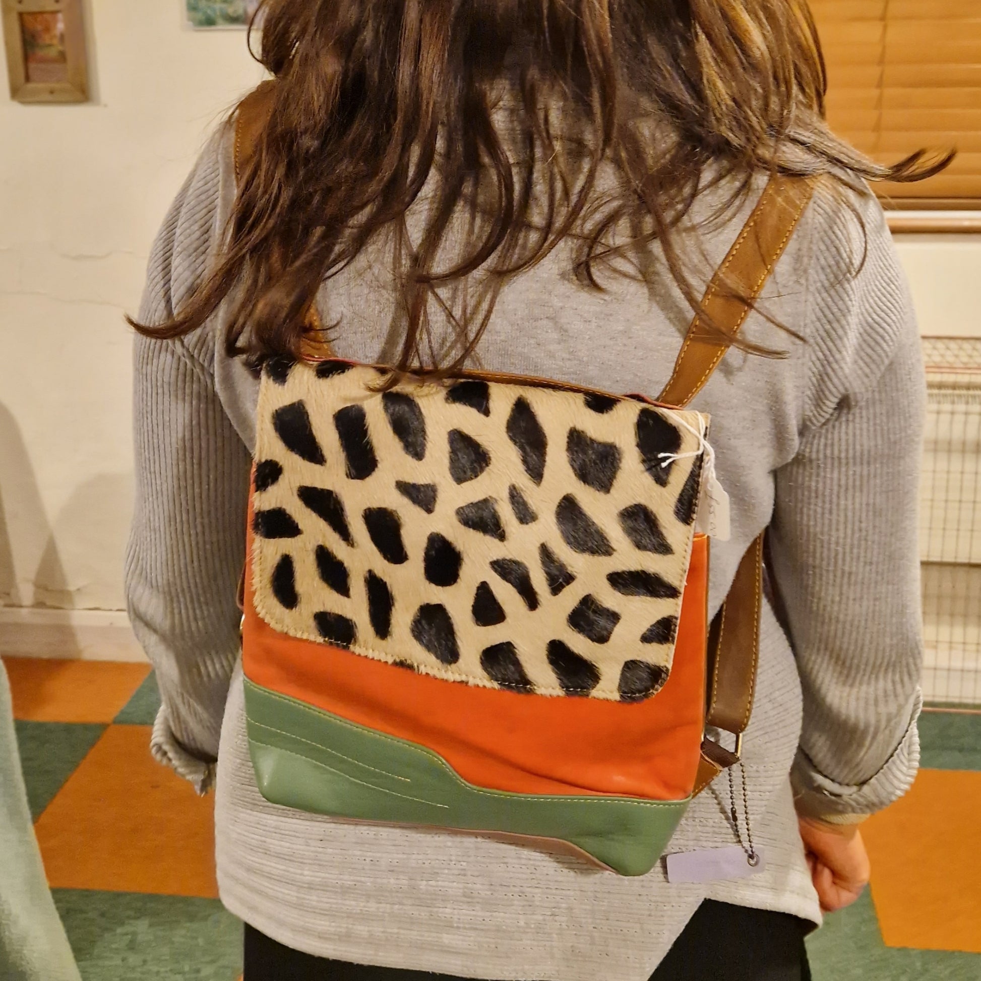 Orange and Green Leather bag with a stylish giraffe print panel.