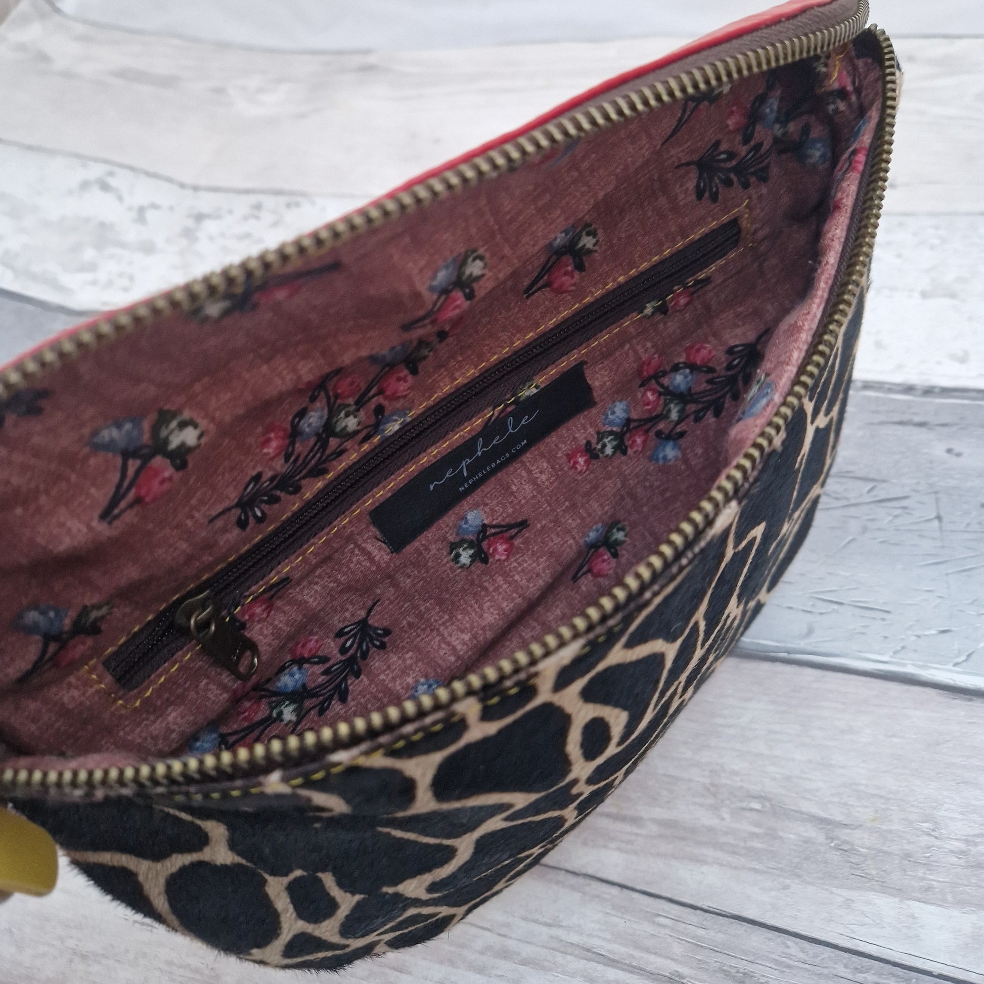 Leather bumbag style bag with a textured front panel in a giraffe print.