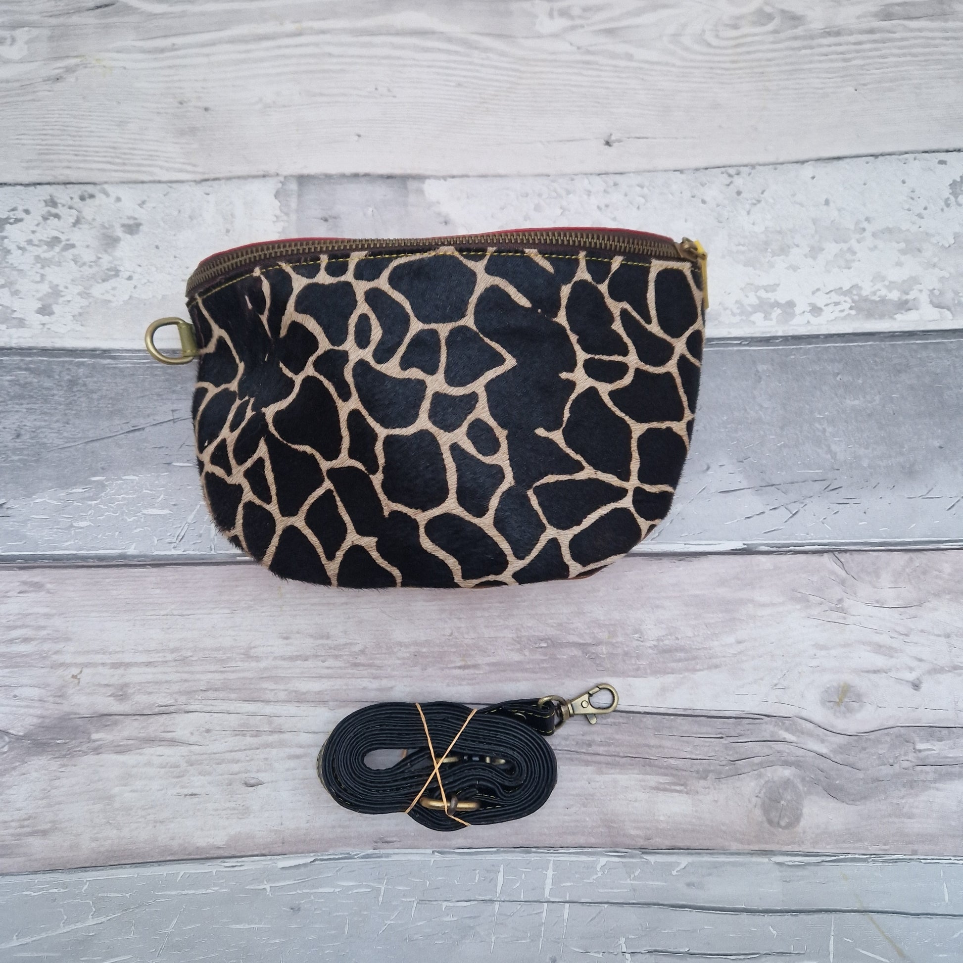 Leather bumbag style bag with a textured front panel in a giraffe print.