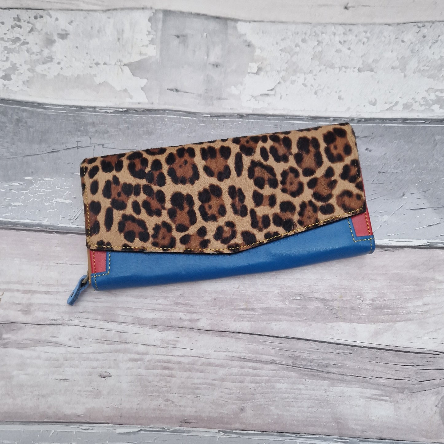 Blue Leather purse with textured front panel in leopard print.