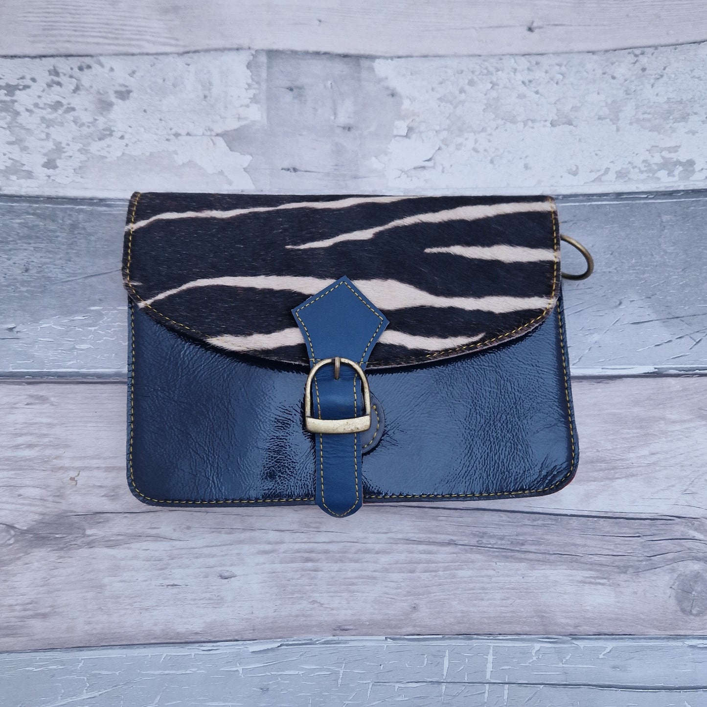 Navy leather bag with a textured panel in Zebra print.