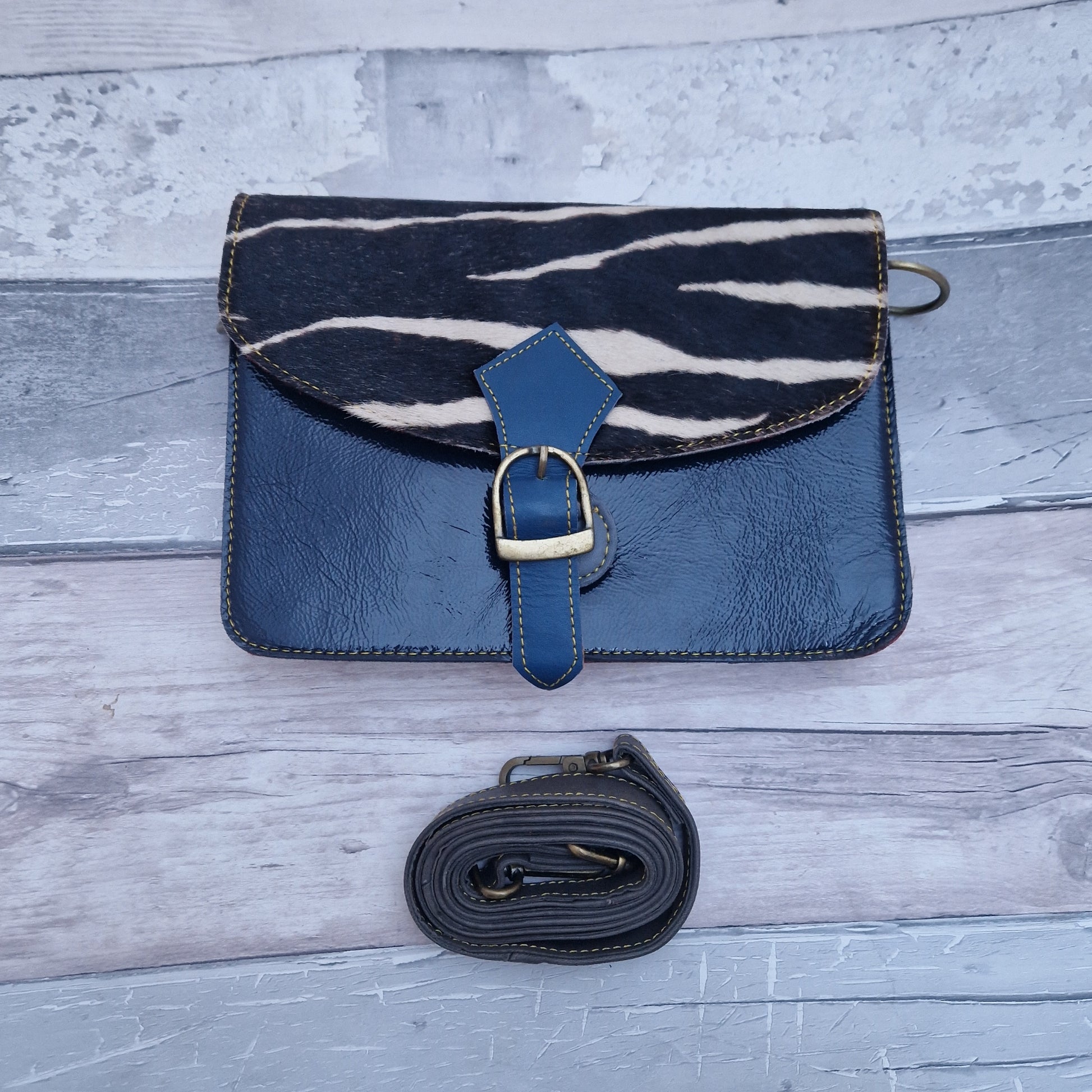 Navy leather bag with a textured panel in Zebra print.