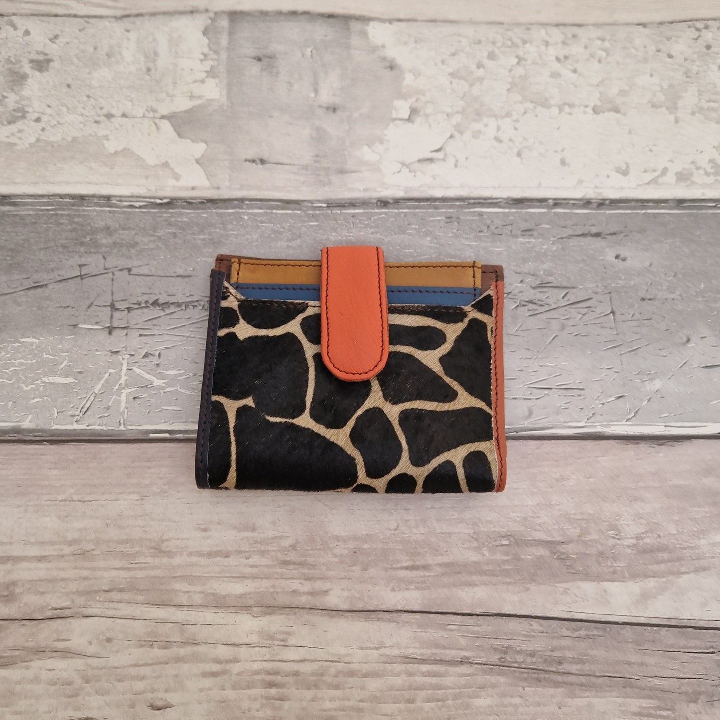 Leather ladies wallet with a textured front panel in giraffe print.