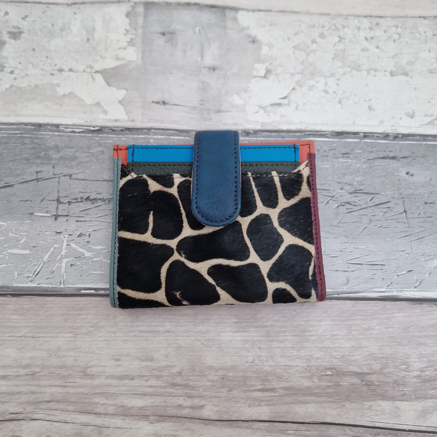 Giraffe print leather card wallet with a textured finish.