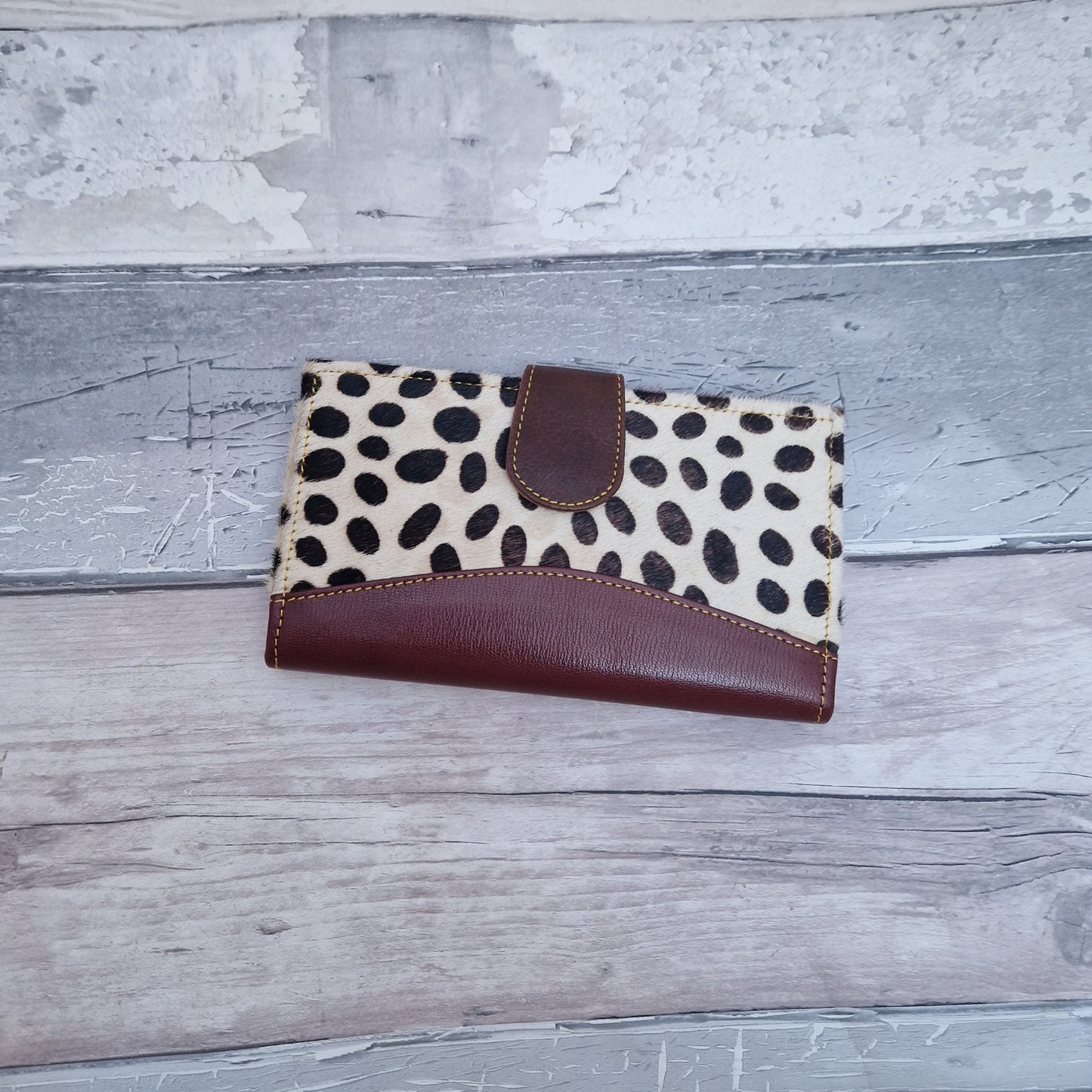 All leather purse with a spot print textured finish.