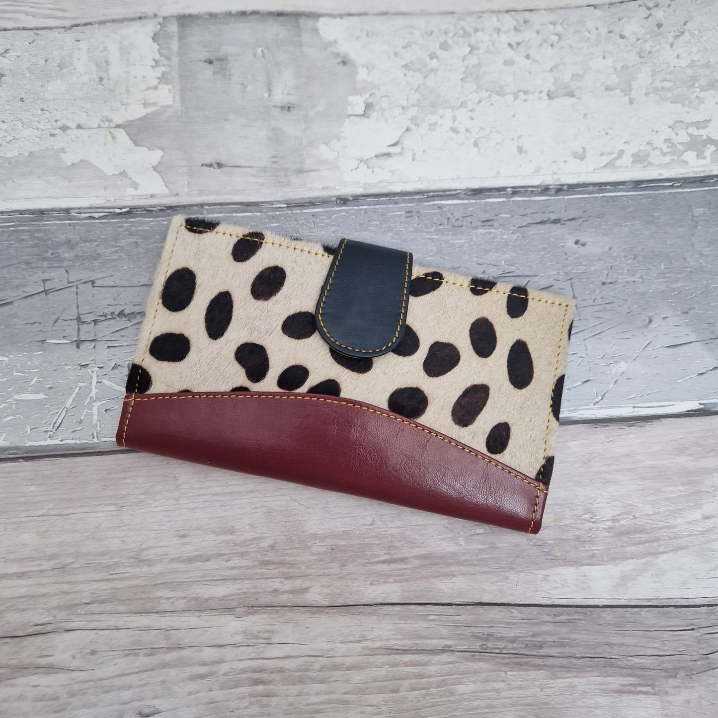 All leather purse with a spot print finish.
