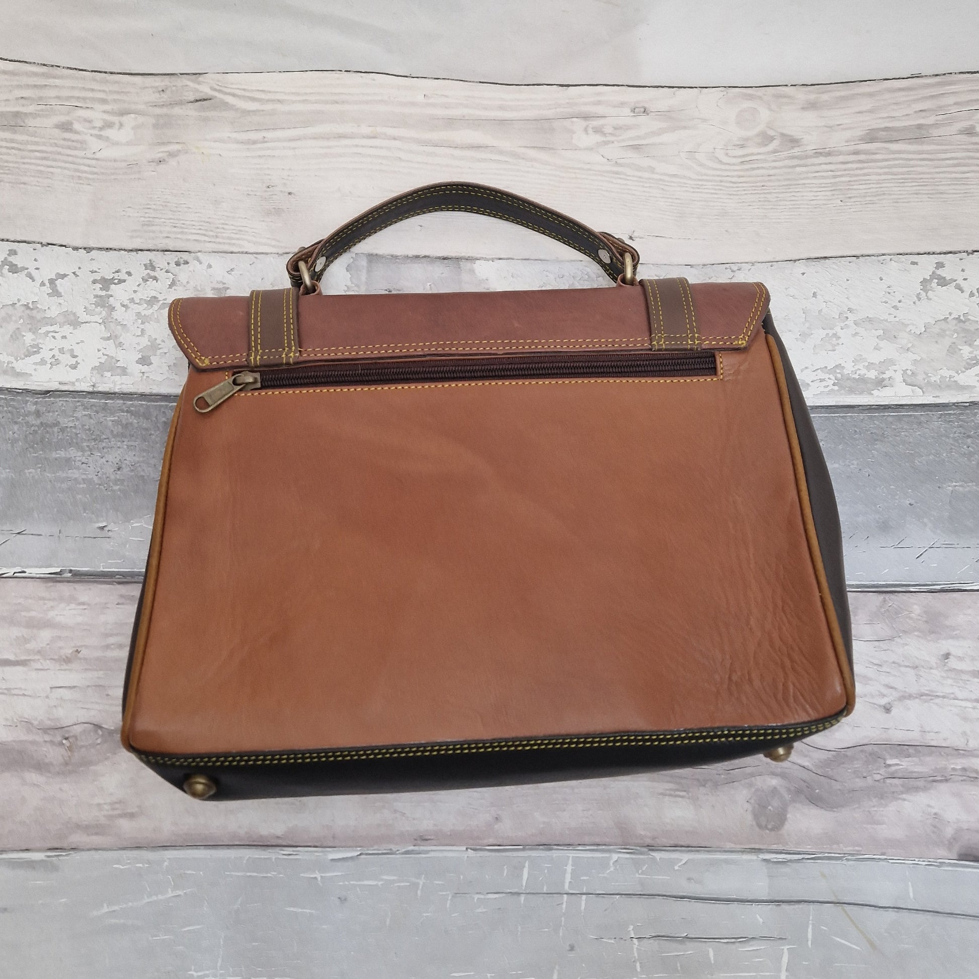 Satchel style leather bag in mulitple shades of brown, finished with brass fixings and buckles.