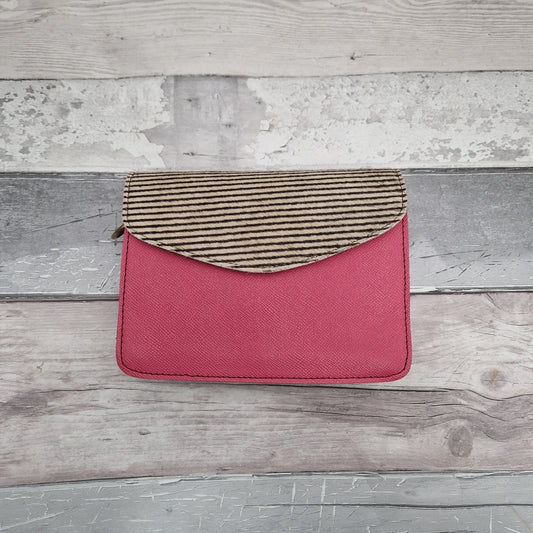 Bubble gum pink coloured leather bag with a textured striped panel of black and white.