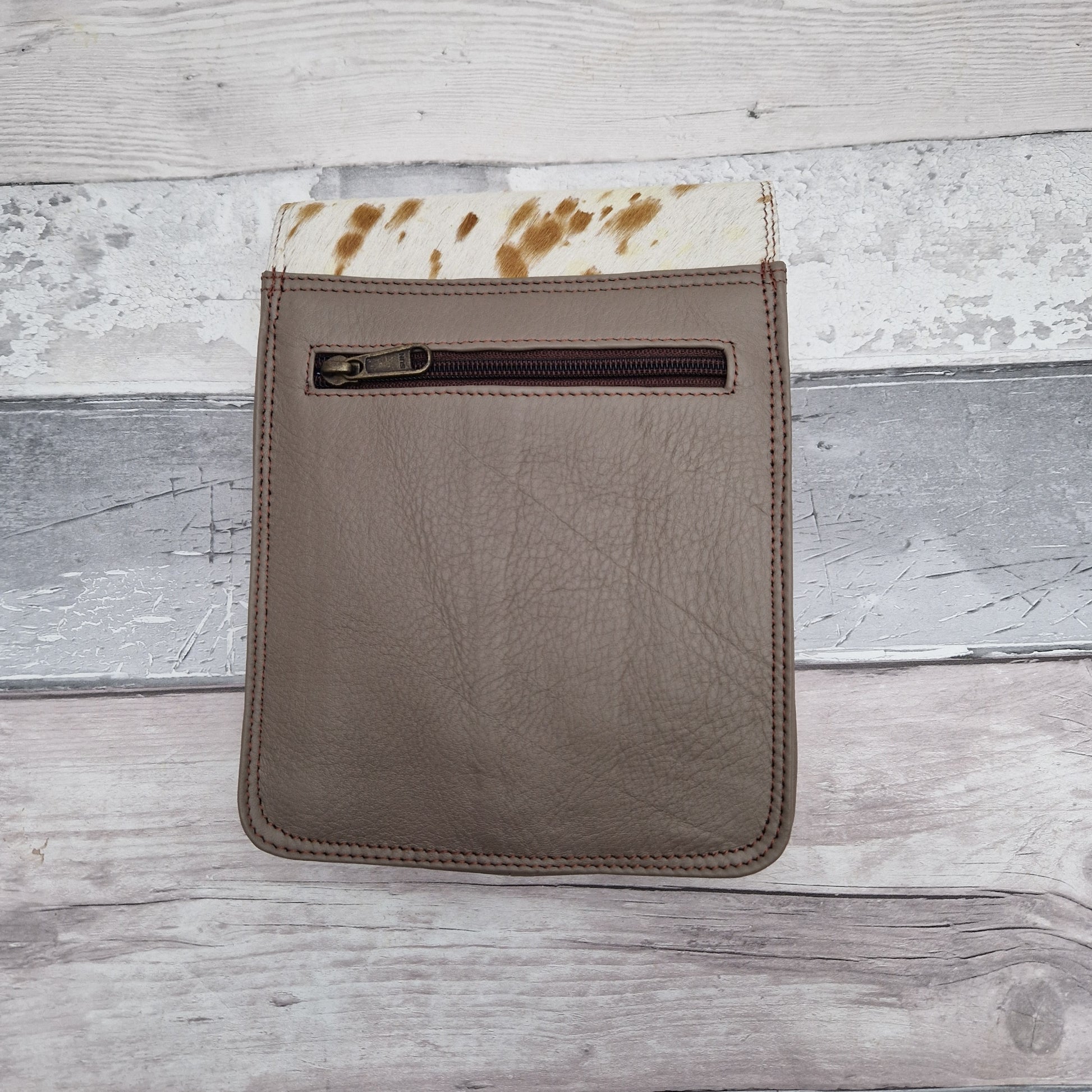 Messenger style bag made from mulit coloured leather off cuts with a textured panel of cow hide.