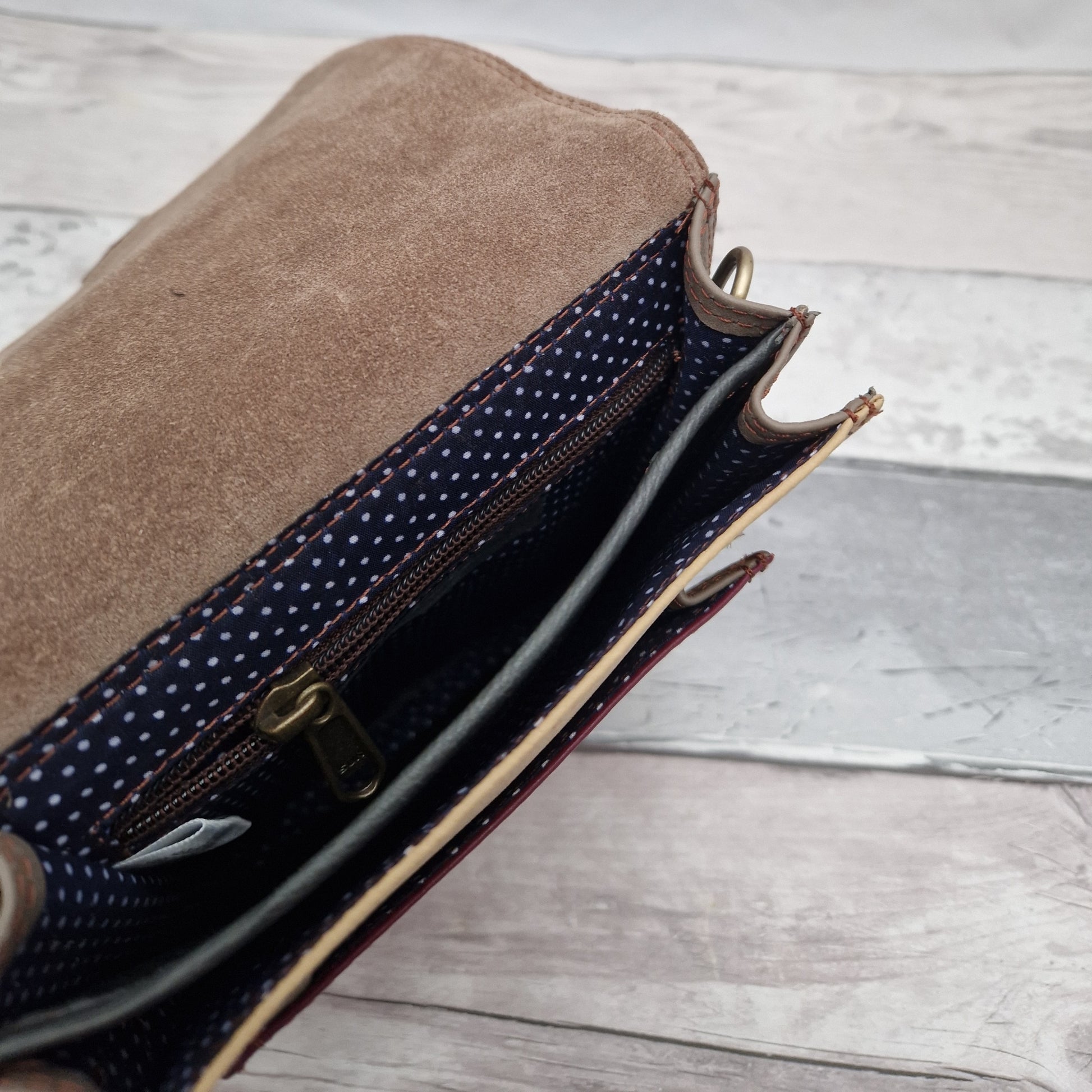 Messenger style bag made from mulit coloured leather off cuts with a textured panel of cow hide.