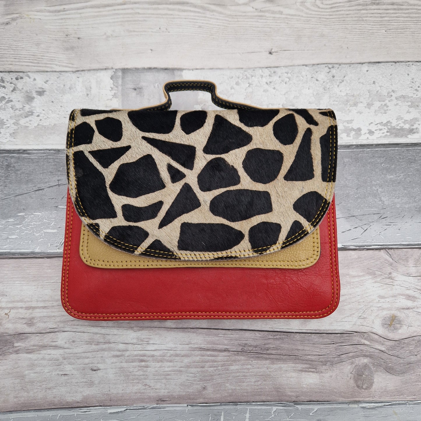 Giraffe print leather made entirely from off cuts in a rainbow of colours.