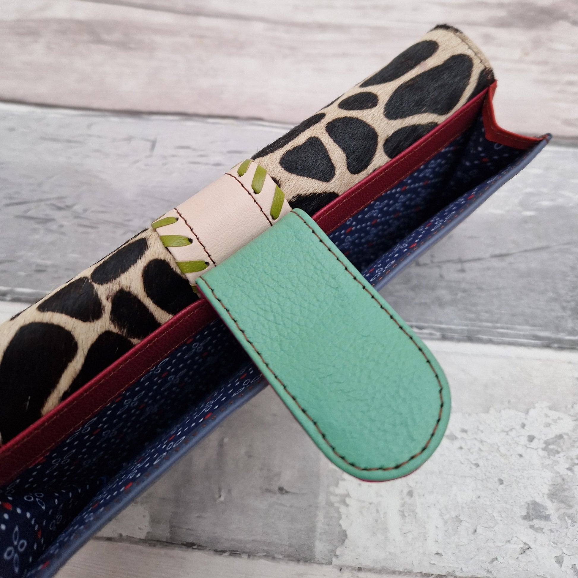 Giraffe print purse made entirely from leather off cuts in a rainbow of colours.