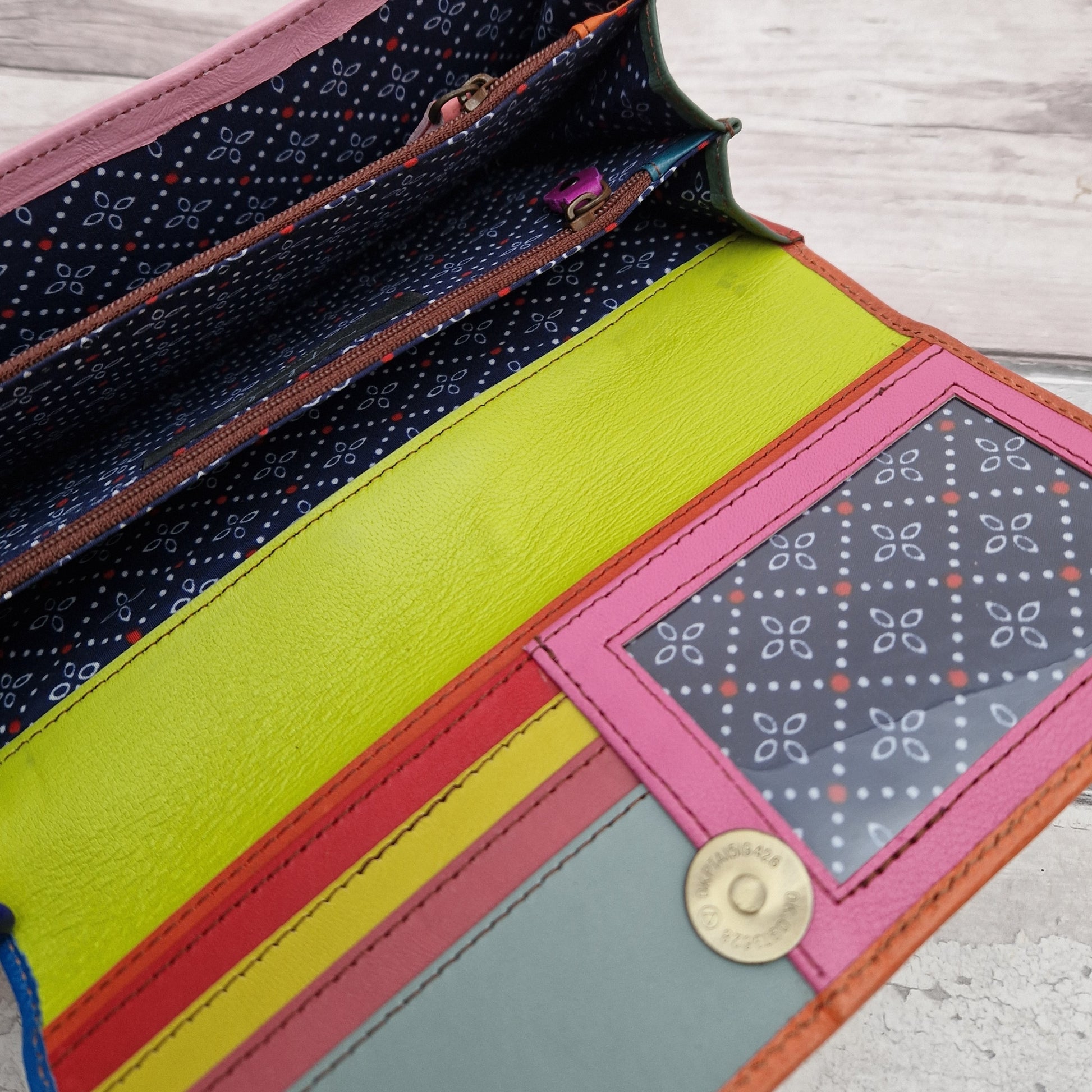 Giraffe print purse made entirely from leather off cuts in a rainbow of colours.